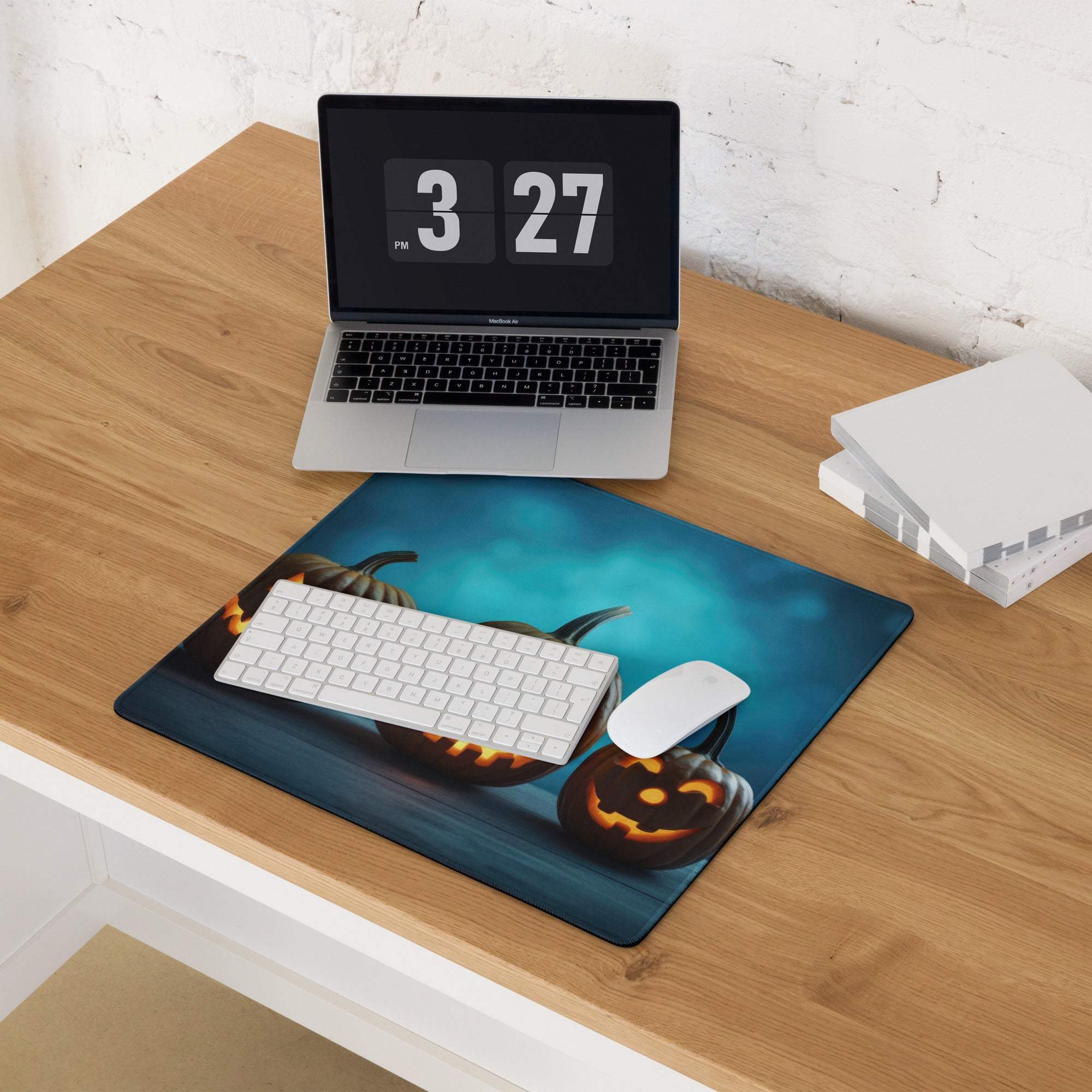 Halloween pumpkin carving gaming mouse pad with orange glow on dark blue