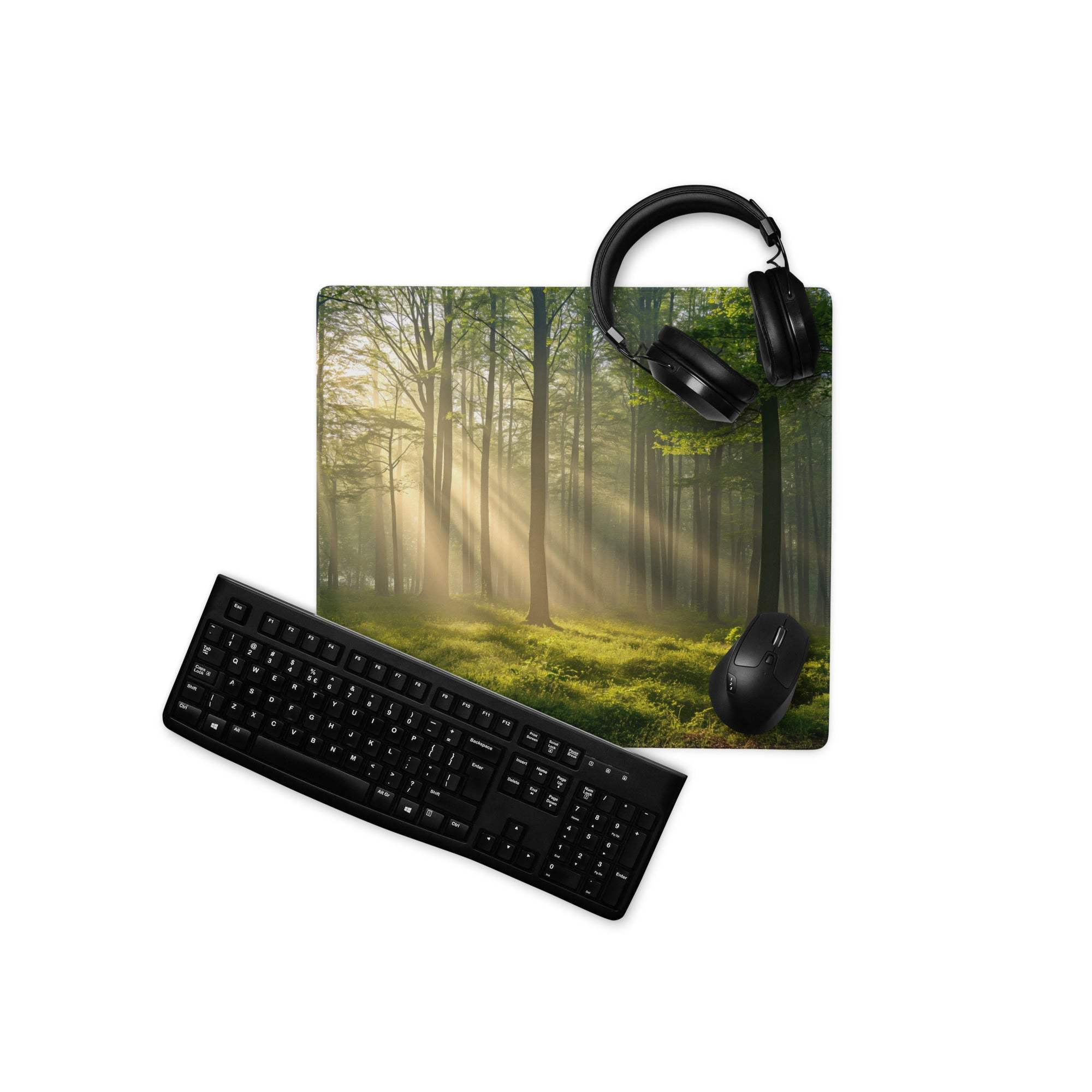 Black keyboard mouse set on forest sunlight gaming mousepad with headphones