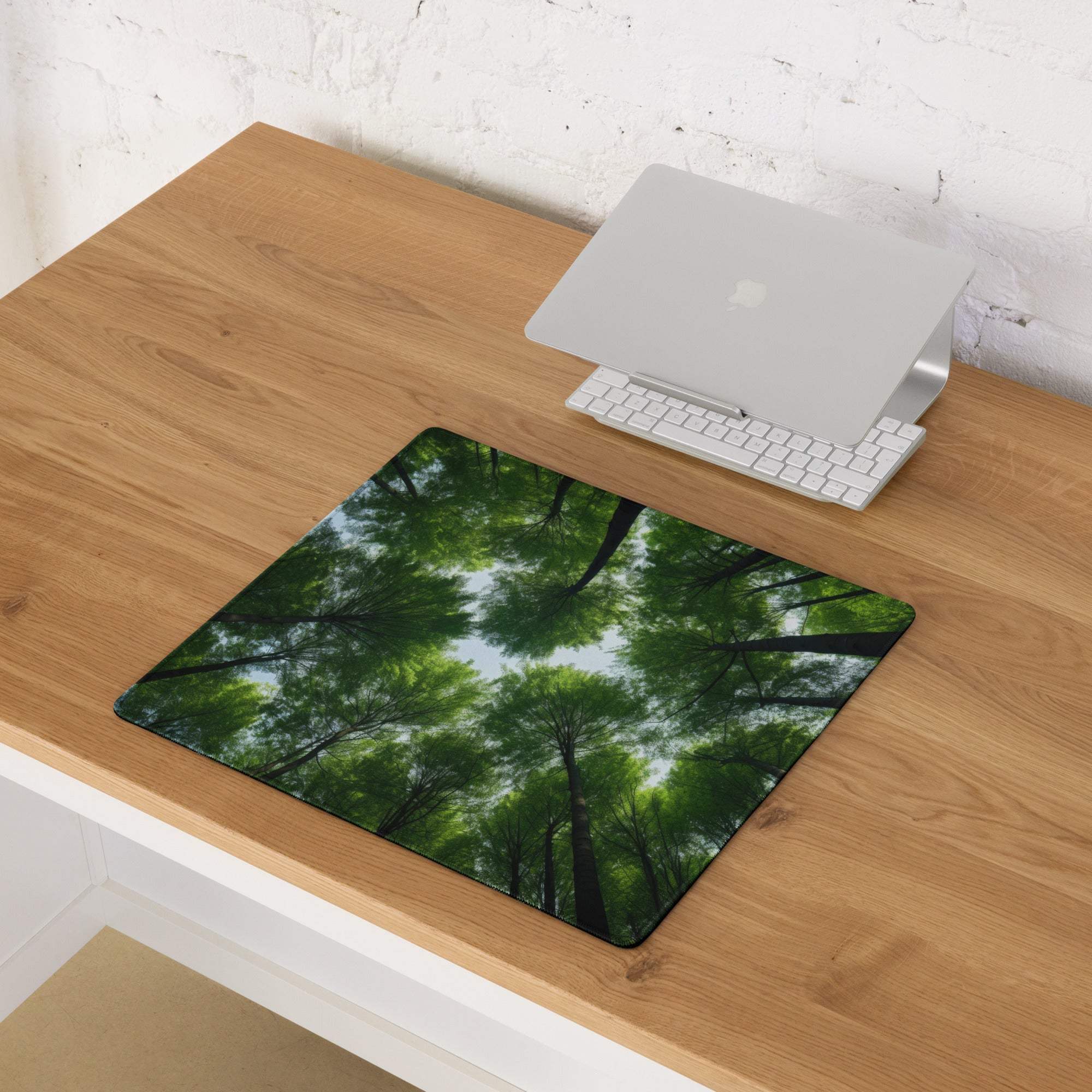 Large forest canopy gaming mouse pad with green trees, blue sky, black border, non-slip stitched edges
