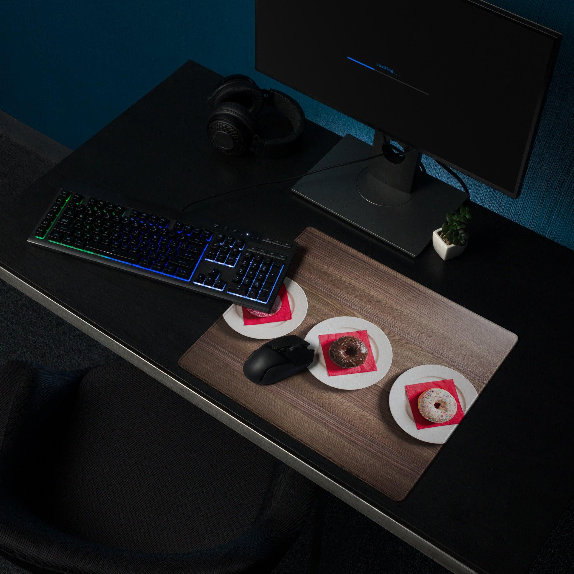 Black RGB gaming keyboard on wood grain brown large mouse pad