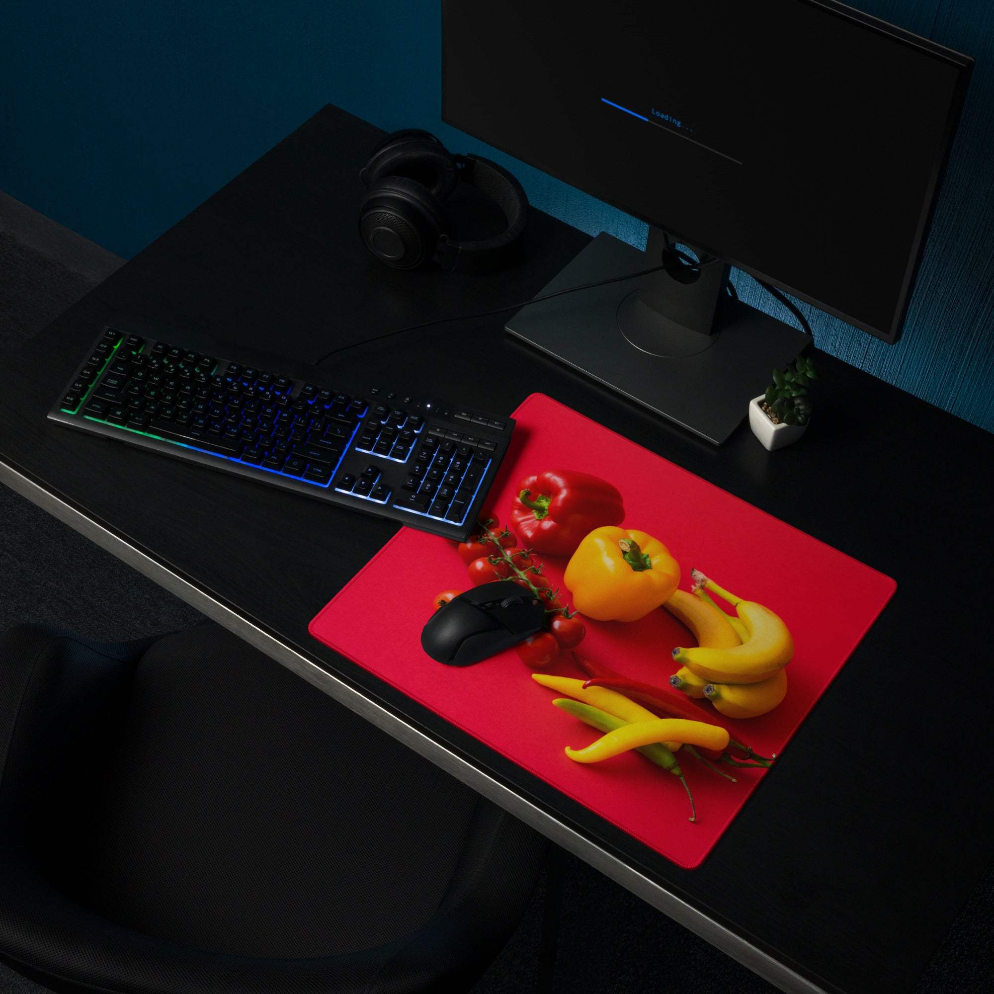 Red rectangular gaming mouse pad with fresh veggies and black mouse