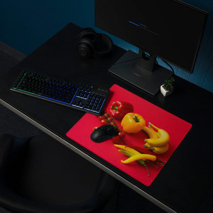 Red rectangular gaming mouse pad with fresh veggies and black mouse