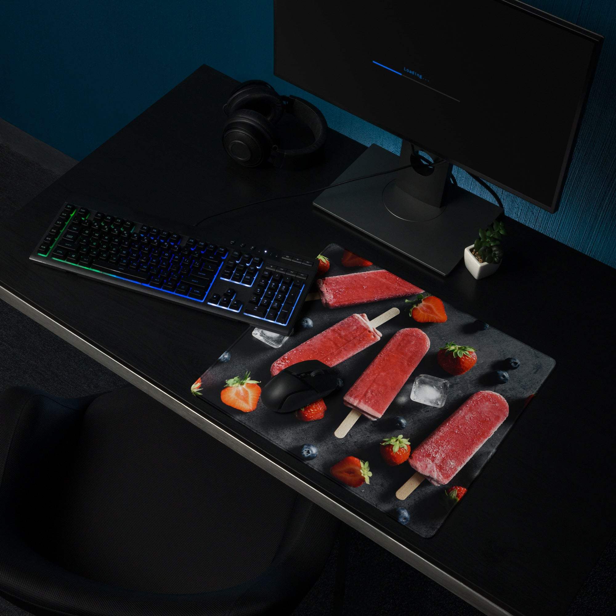 Large gaming mouse pad with red strawberry ice cream design on black textured surface