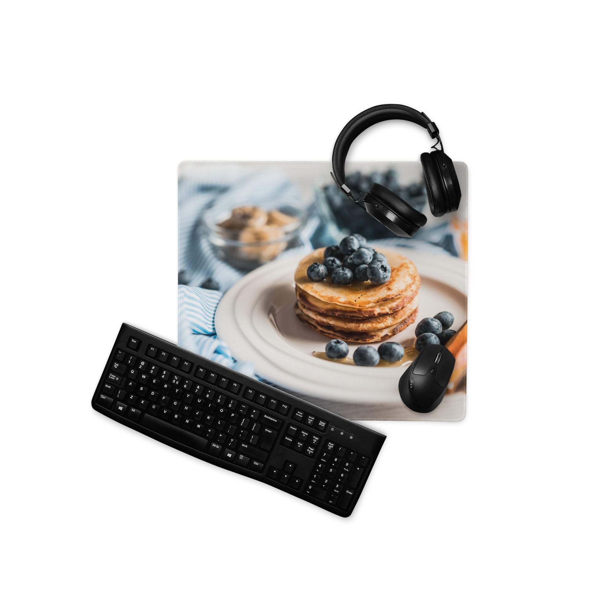 Black matte QWERTY keyboard on blue gaming mouse pad