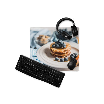 Black matte QWERTY keyboard on blue gaming mouse pad