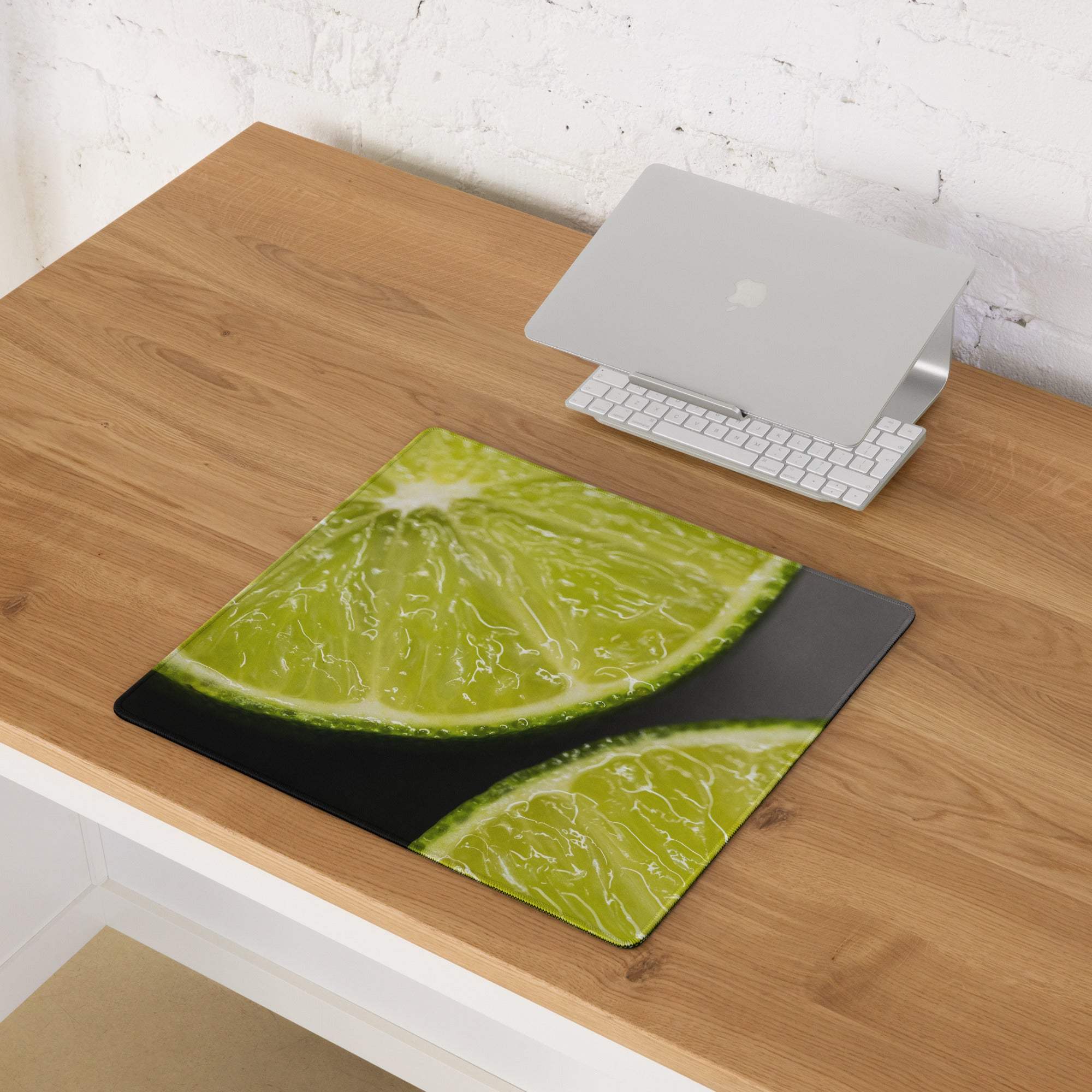 Vibrant lime slice gaming mouse pad with glossy finish, black border, non-slip backing, stitched edges