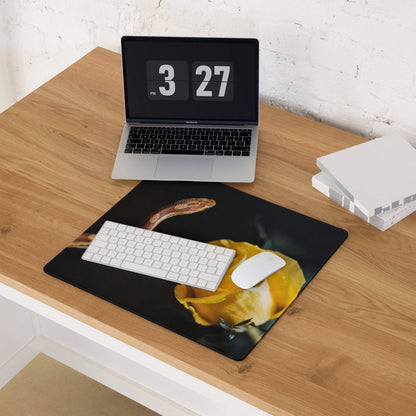 Black gaming mouse pad with yellow rose and coiled orange snake