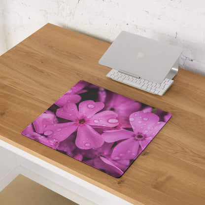 Floral pink bloom gaming mouse pad with water droplets on purple blossoms on wood desk
