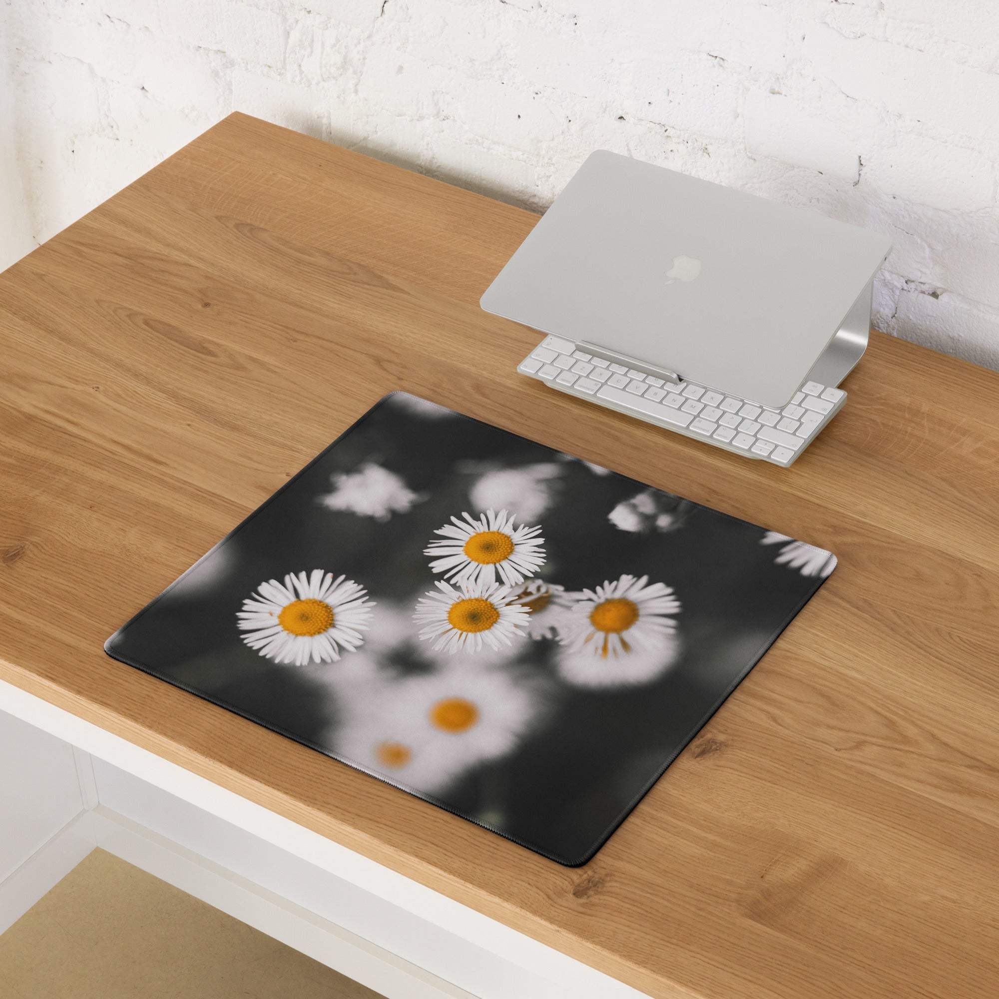 Large black gaming mouse pad with soft-focus white daisy print