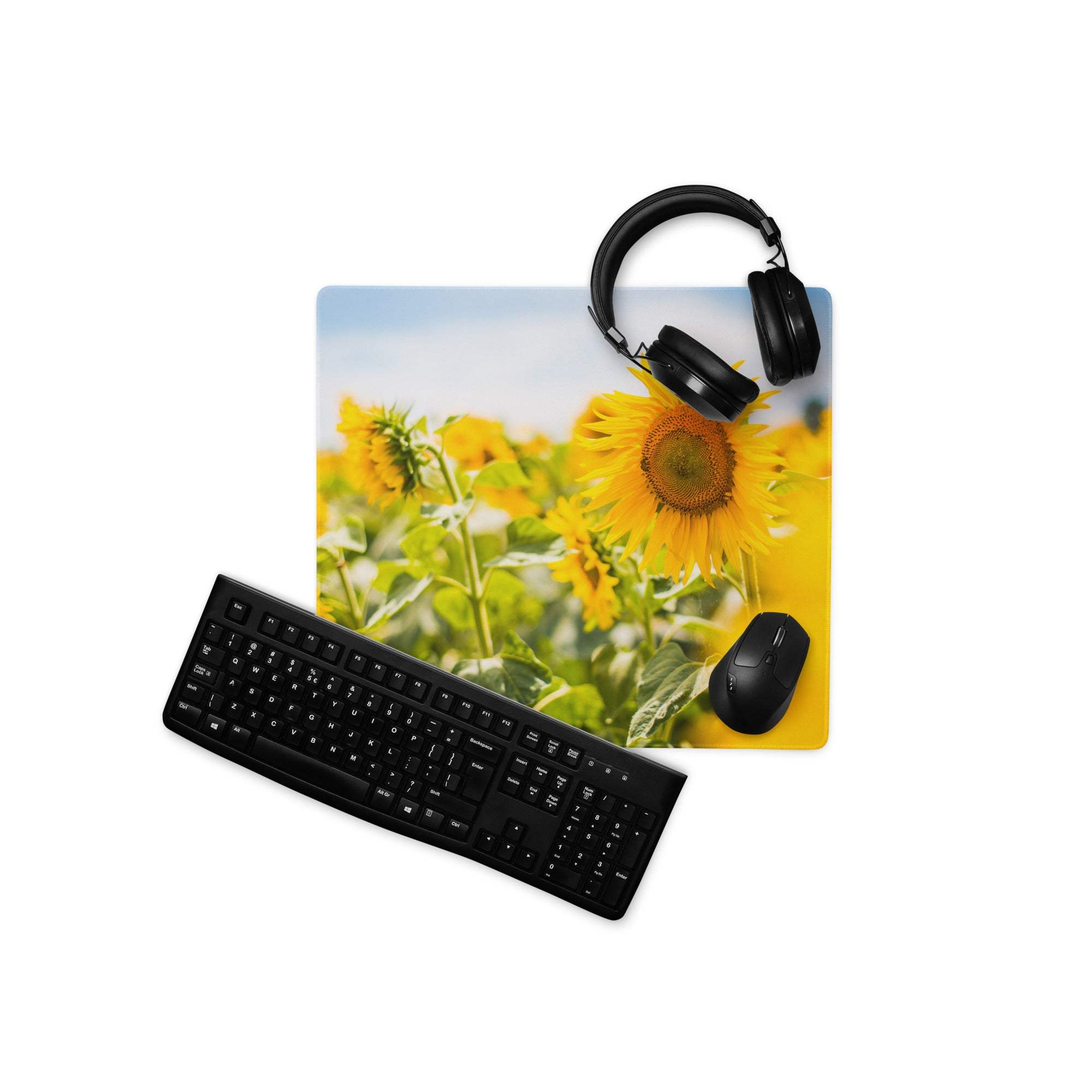 Vibrant yellow sunflower field gaming mouse pad with black keyboard and headphones
