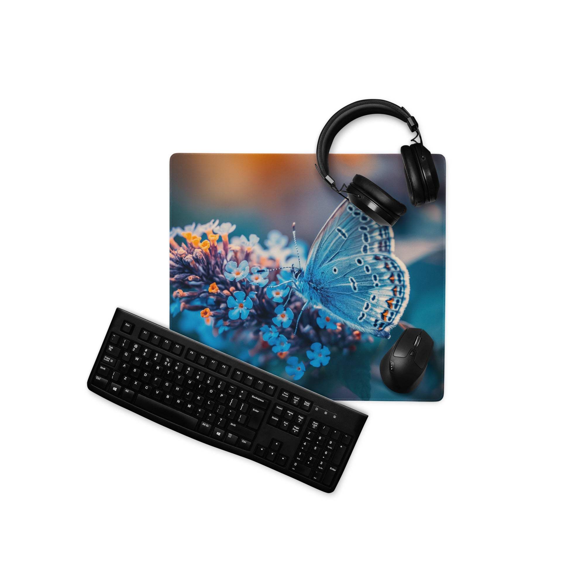 Blue butterfly floral gaming mousepad with non-slip base, black keyboard nearby