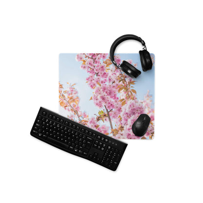 Pink cherry blossom gaming mousepad with black keyboard and headphones