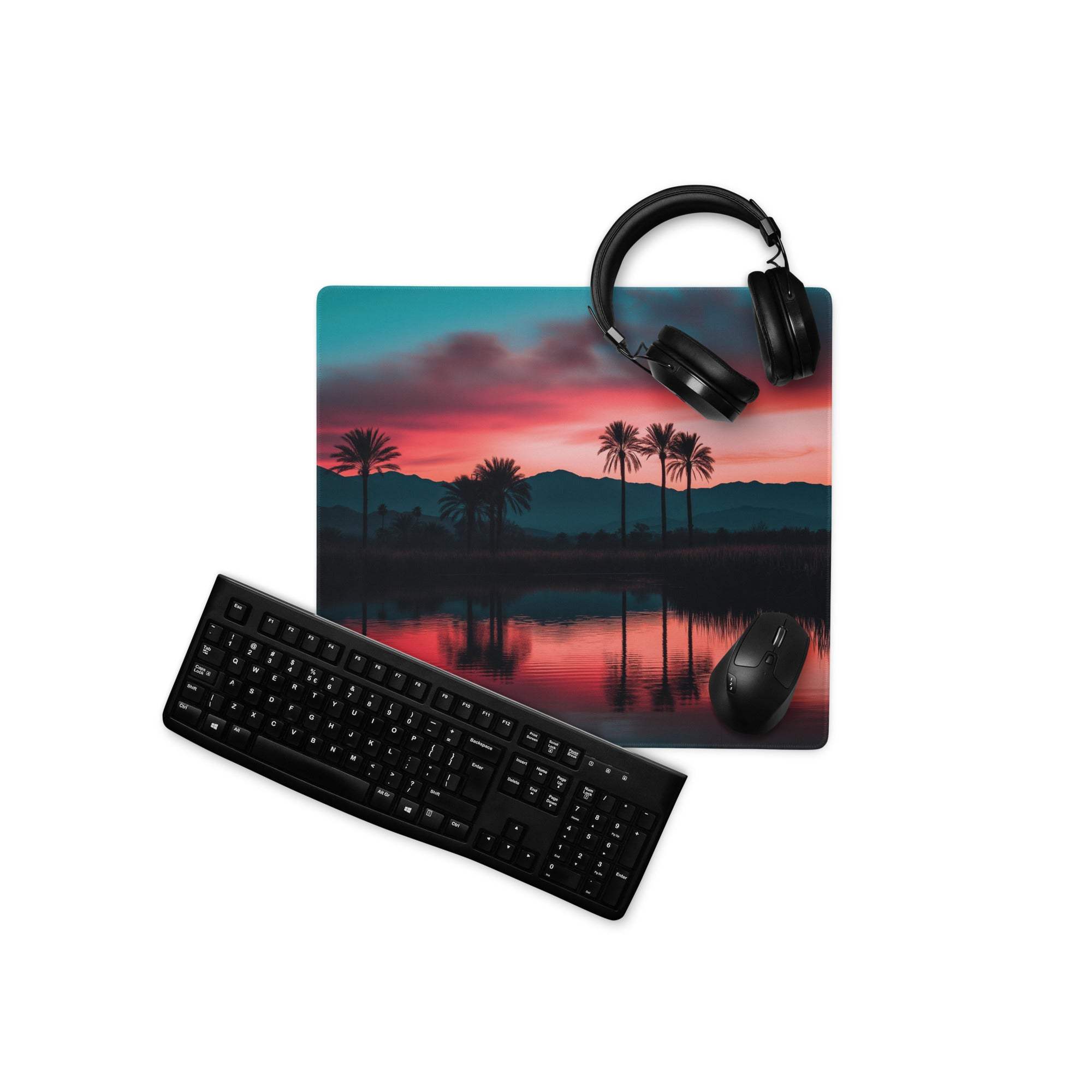 Sleek black minimalist keyboard with matte finish on dreamy sunset palm mouse pad