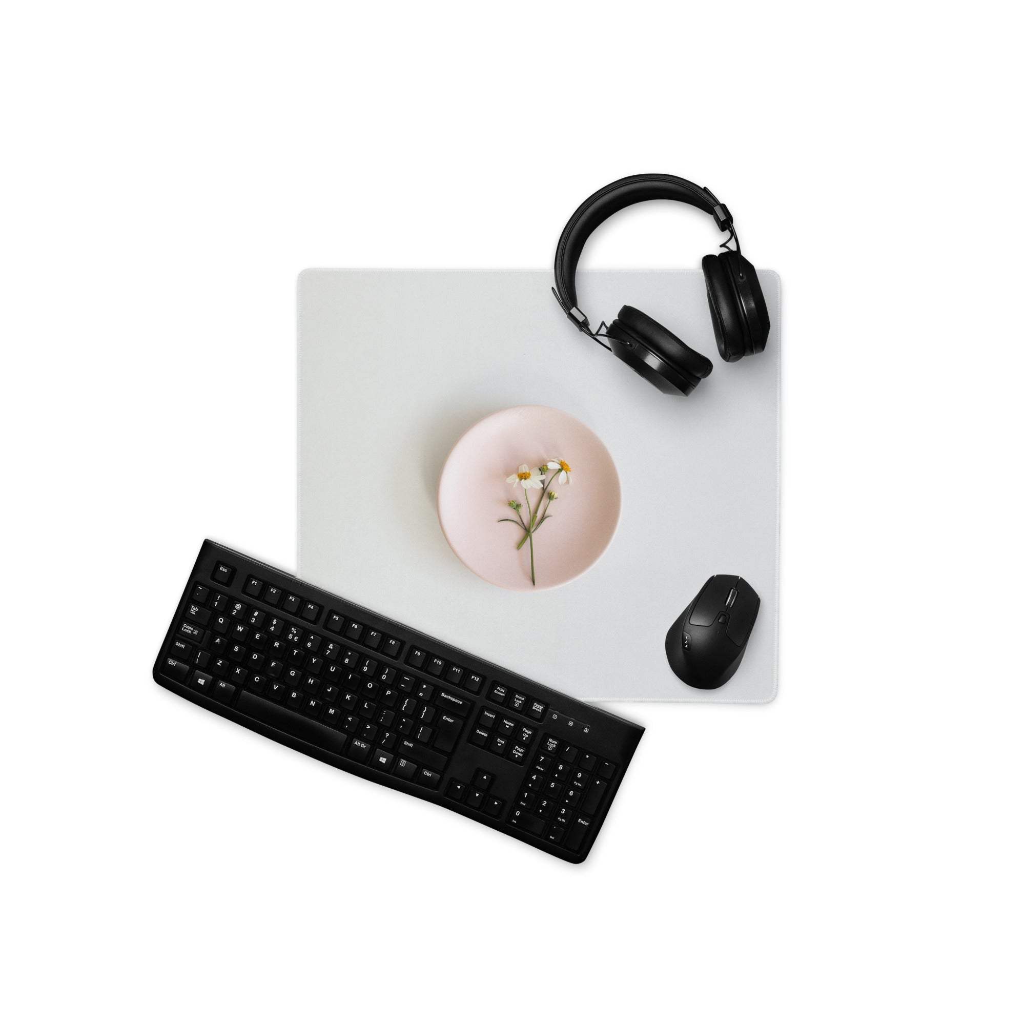 Black wireless QWERTY keyboard on sleek gray gaming mouse pad