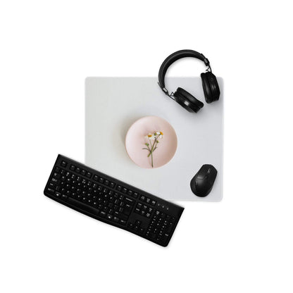 Black wireless QWERTY keyboard on sleek gray gaming mouse pad