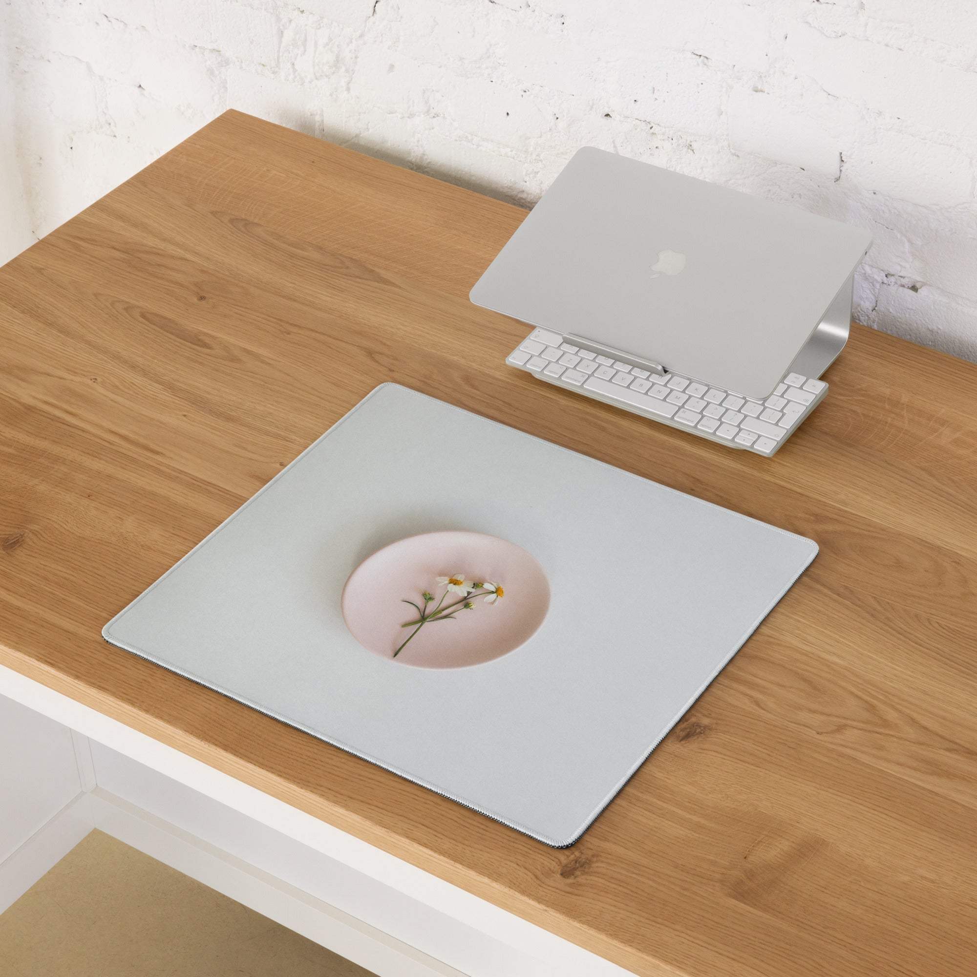 Light gray gaming mousepad with pink bowl of white flowers inset