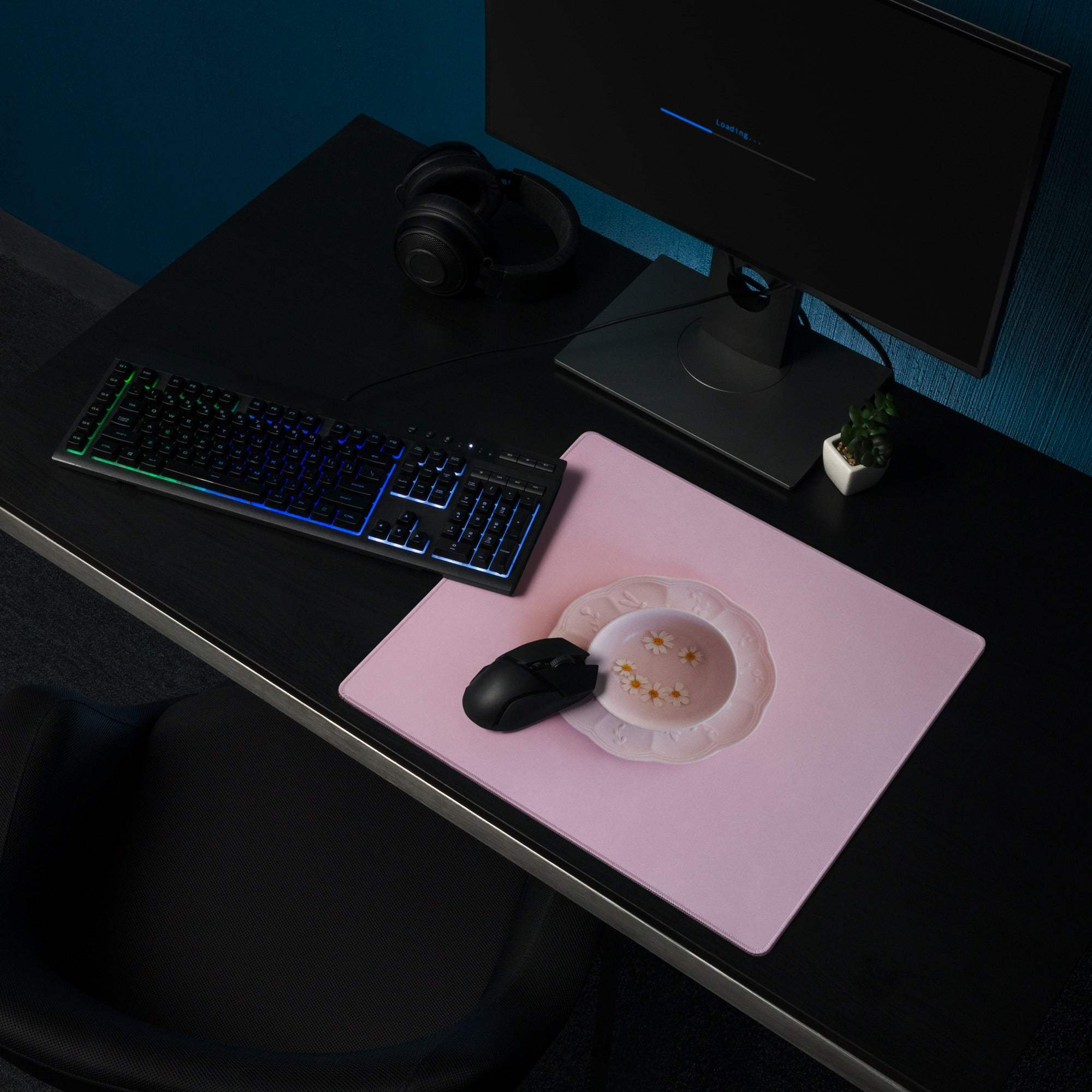 Pink gaming mouse pad with gold star inset, black mouse, non-slip backing