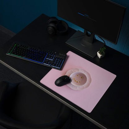 Pink gaming mouse pad with gold star inset, black mouse, non-slip backing
