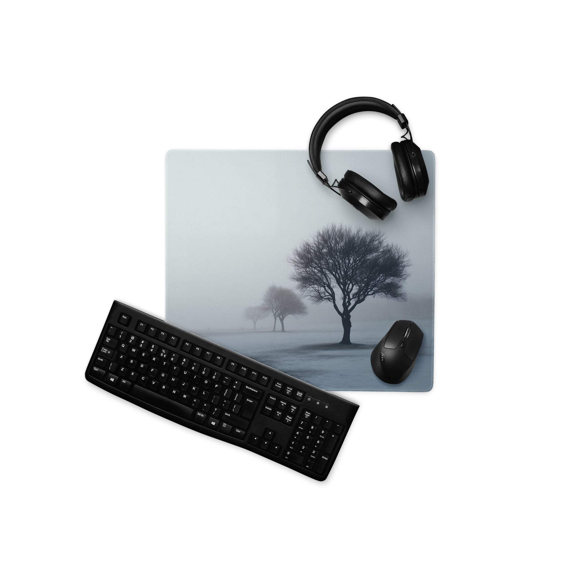 Black keyboard mouse on misty forest gaming mousepad with headphones