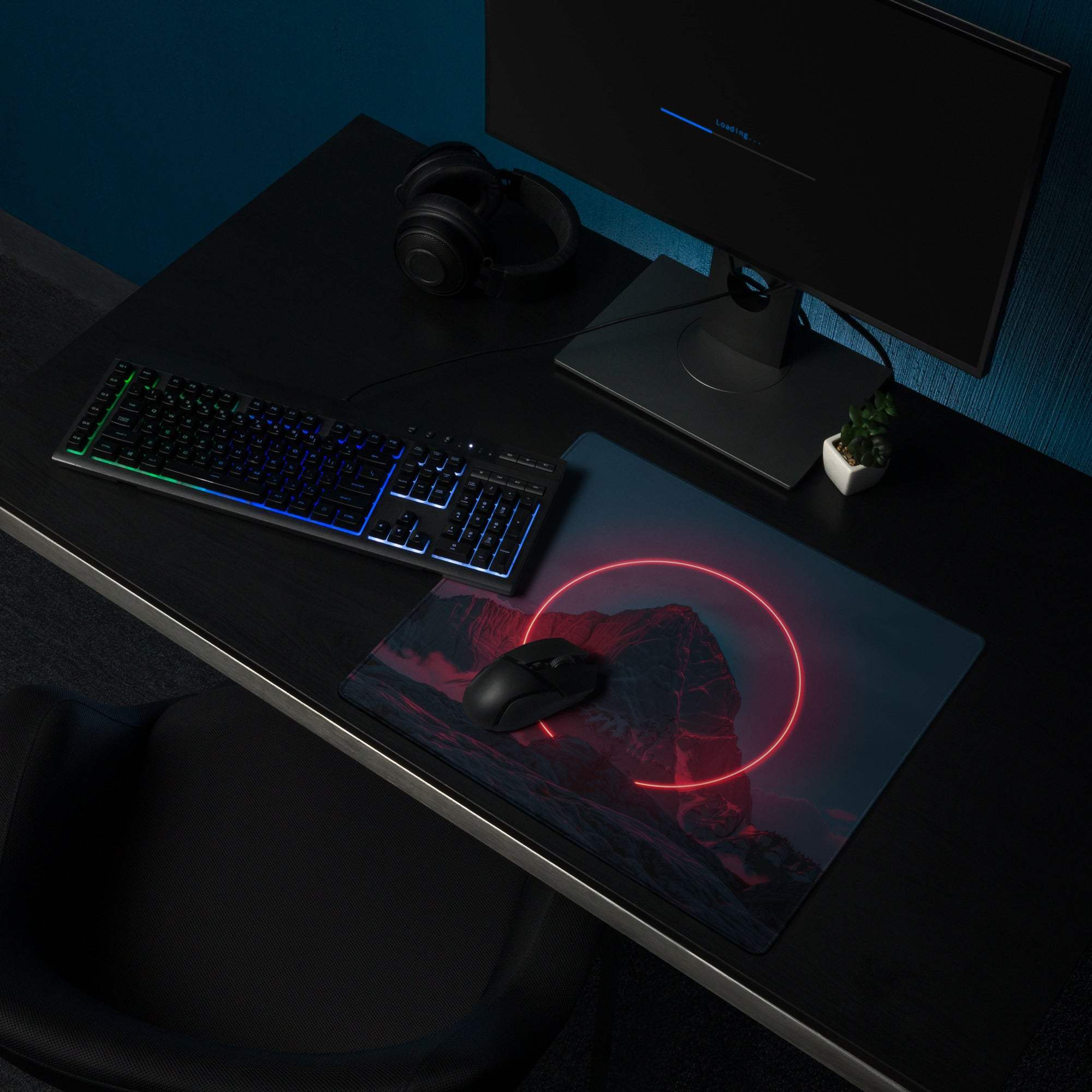 Black gaming mousepad with glowing pink neon circle on cyberpunk dark mountain night scene