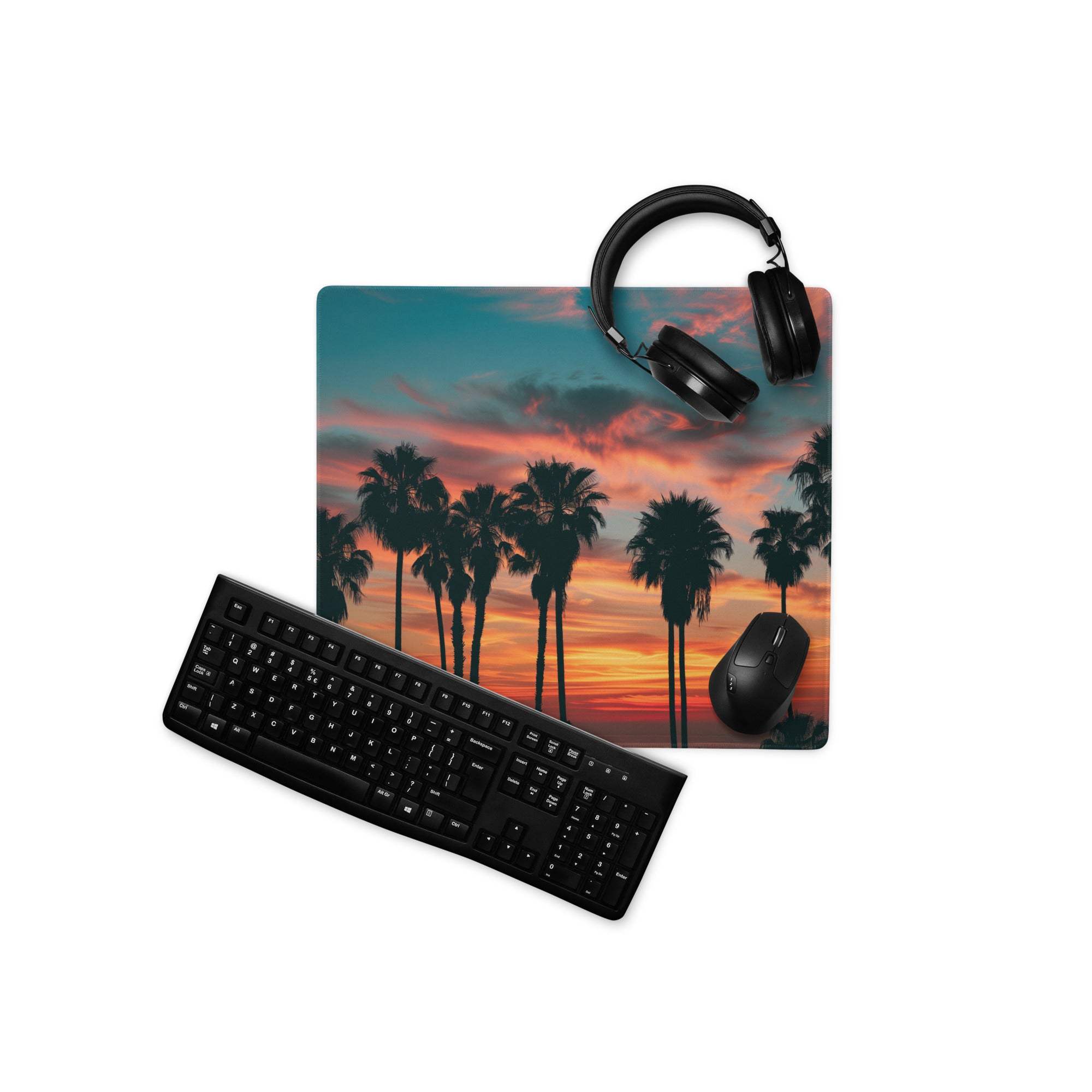Sleek black matte keyboard on epic sunset palm tree gaming mouse pad