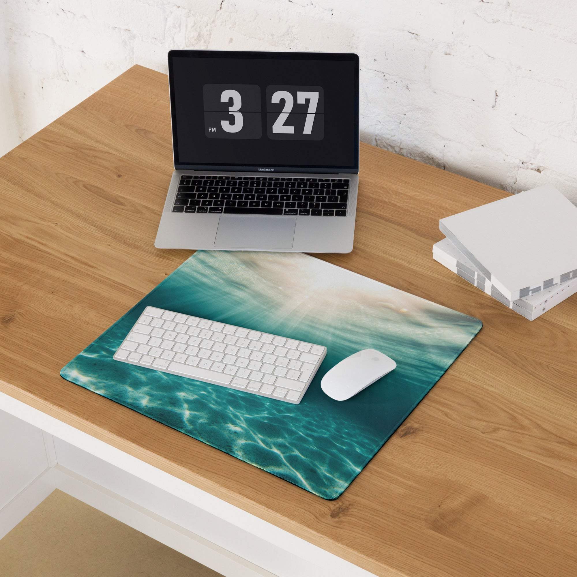 Teal ocean wave gaming mouse pad with sheen, non-slip surface, stitched edges