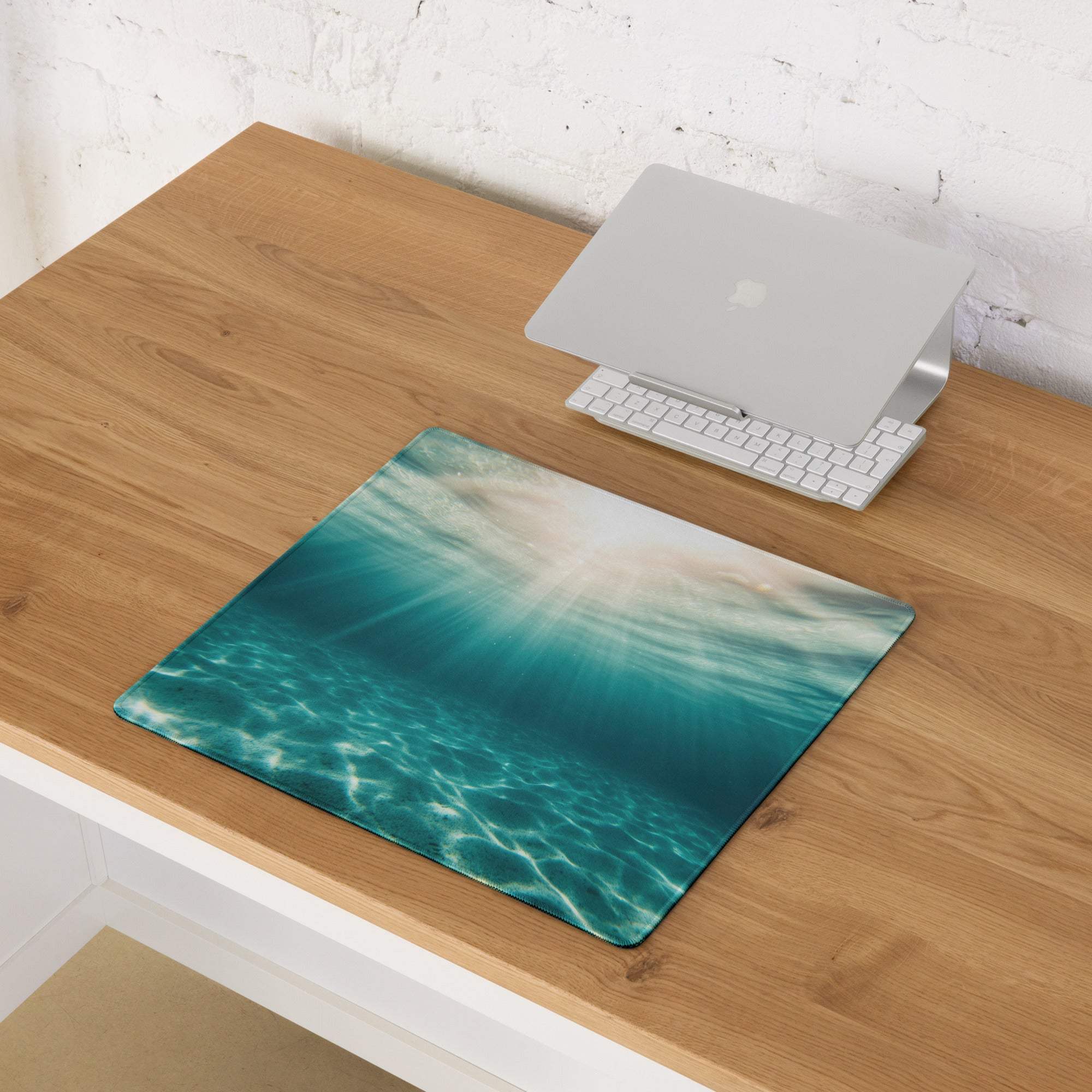 Large underwater ocean scene gaming mouse pad with turquoise hues and sunlight rays