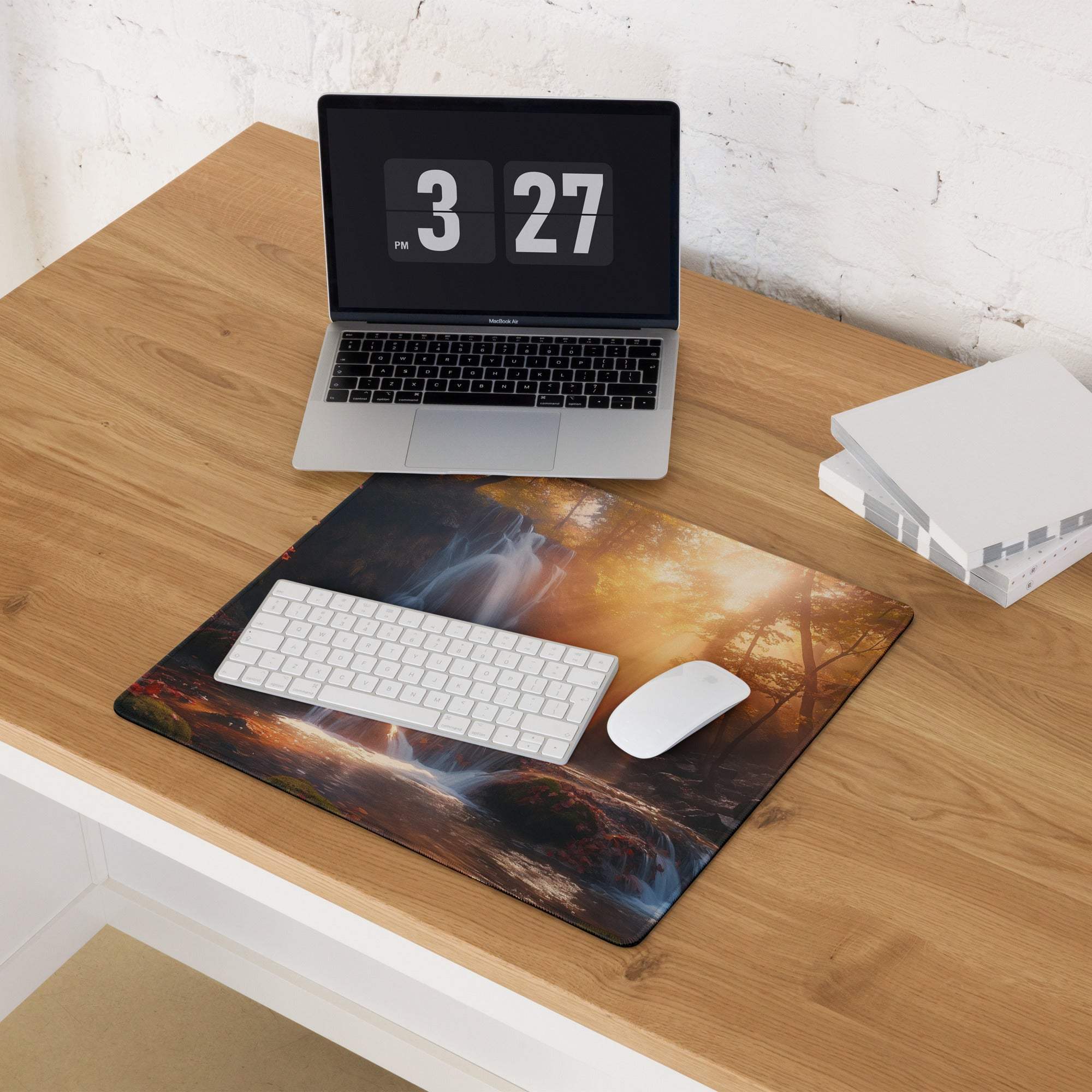 Large edge-stitched gaming mousepad with misty golden hour forest waterfall print