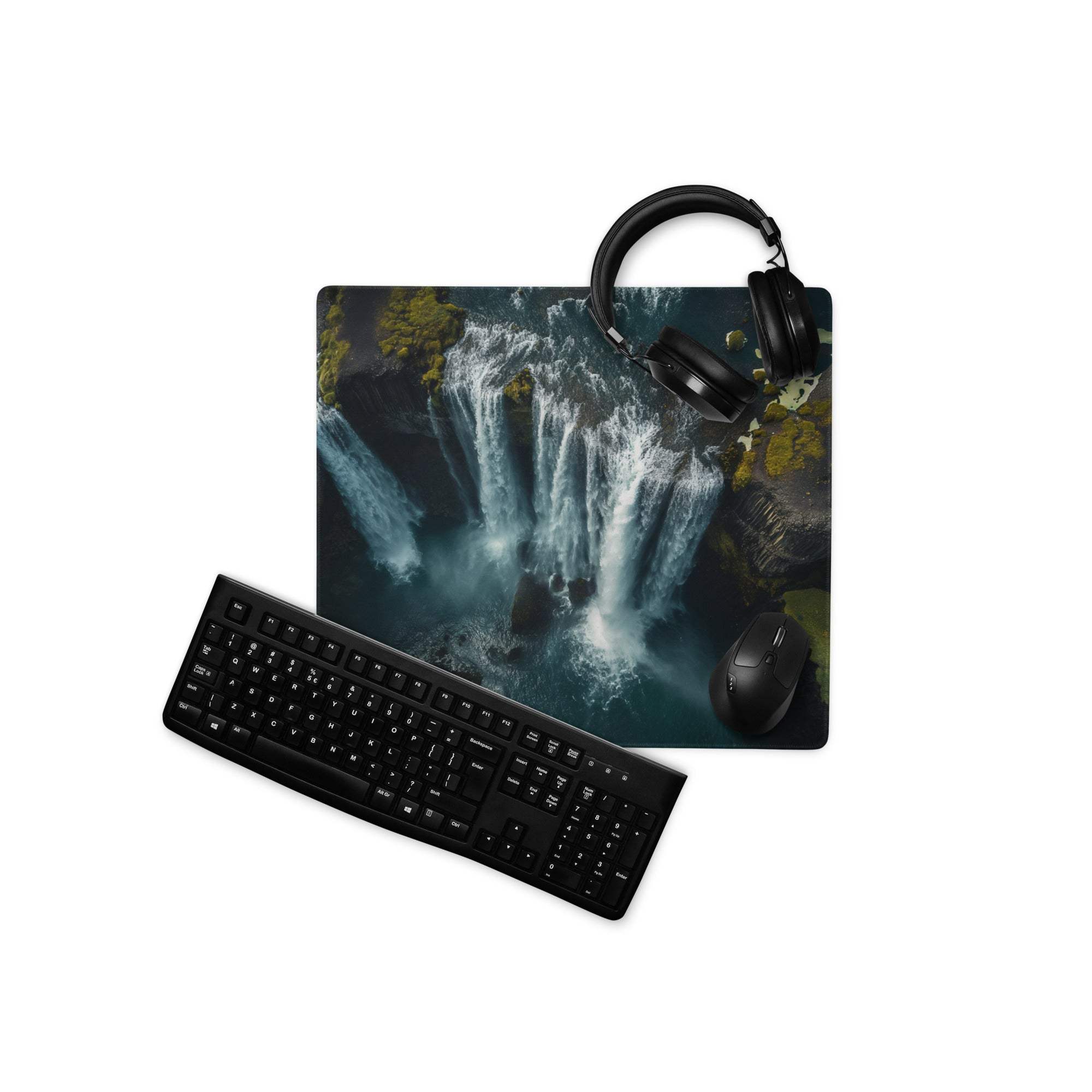 Black keyboard and mouse on moody waterfall gaming mouse pad