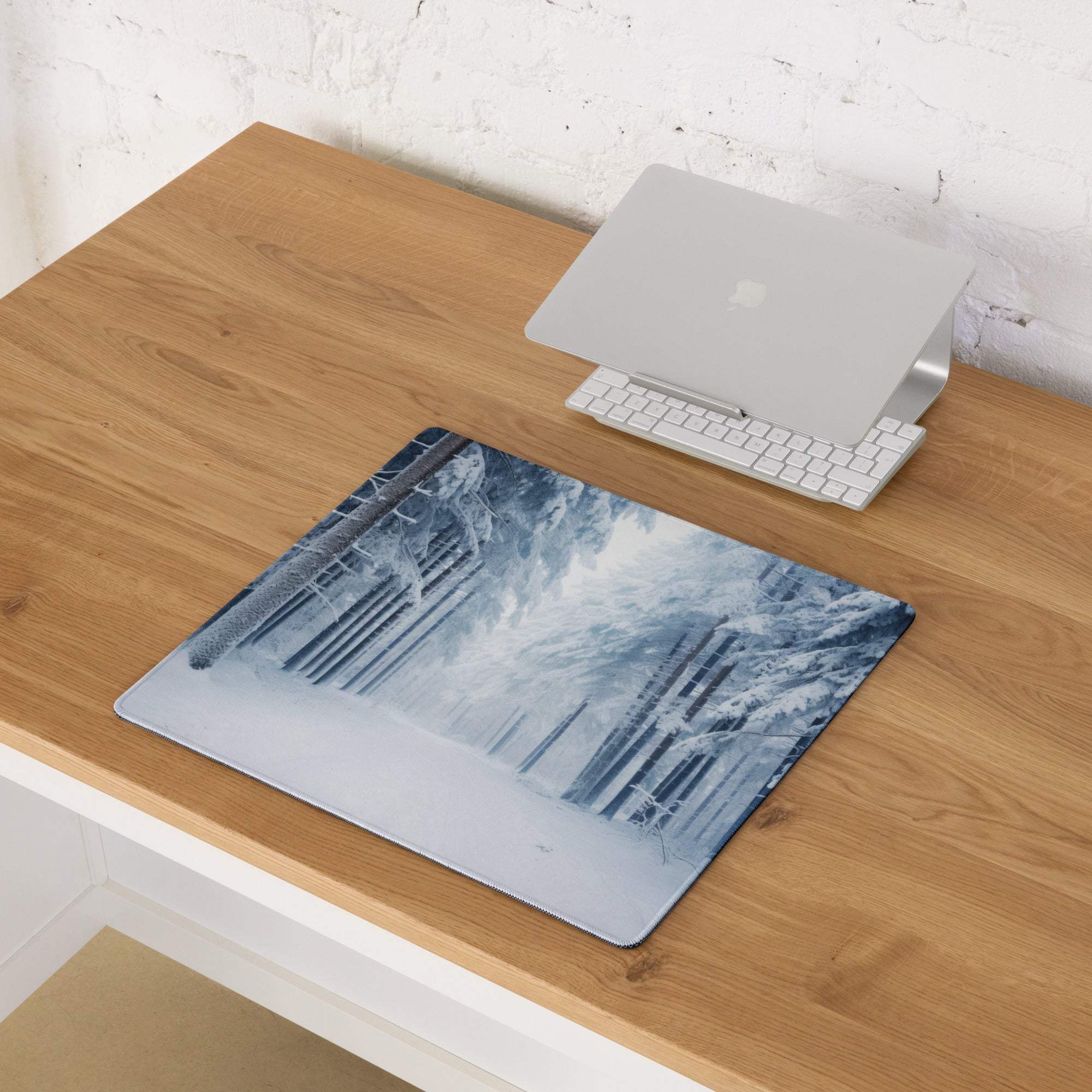 Blue and white snowy forest gaming mouse pad with non-slip base