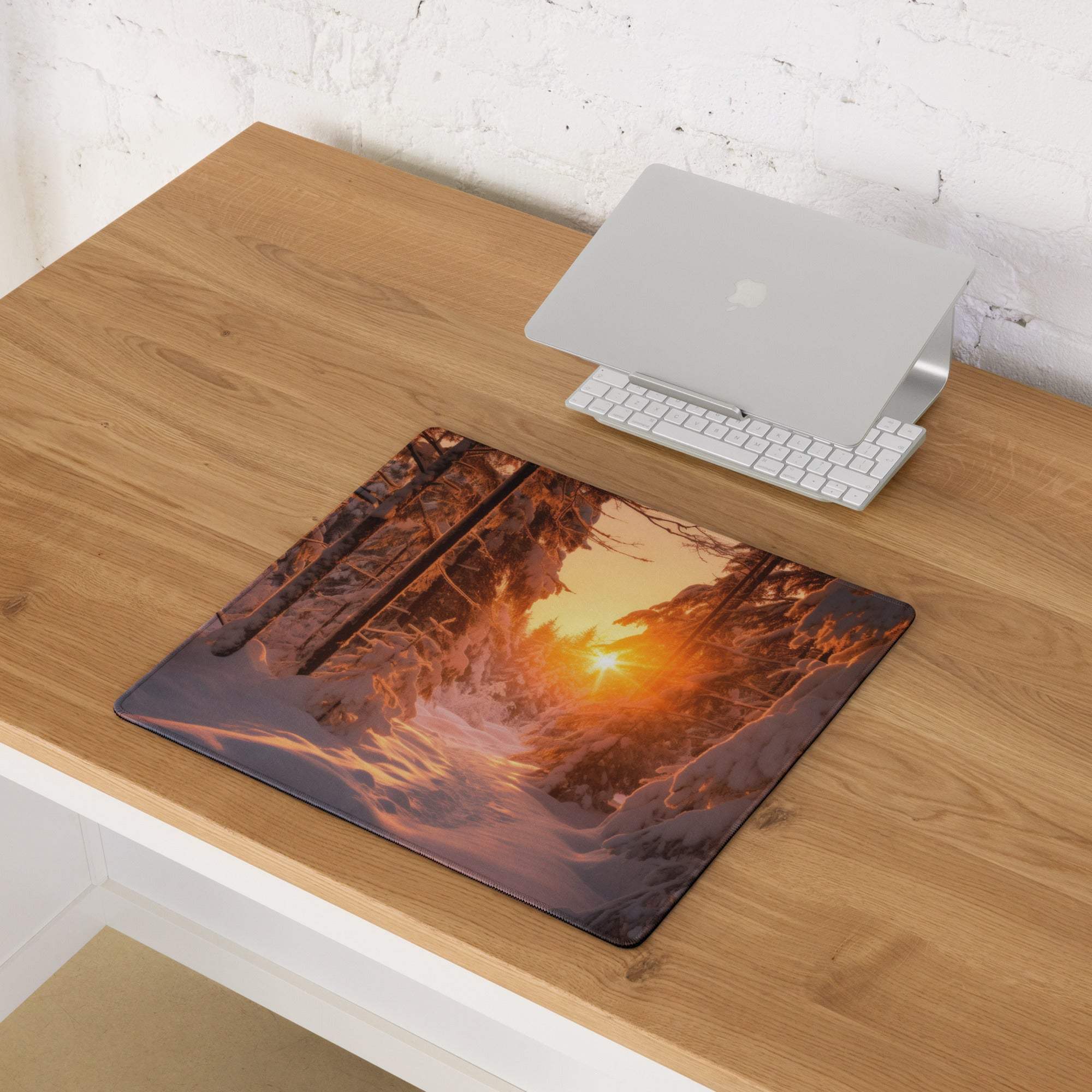 Vivid snowy forest sunrise gaming mouse pad with warm orange glow