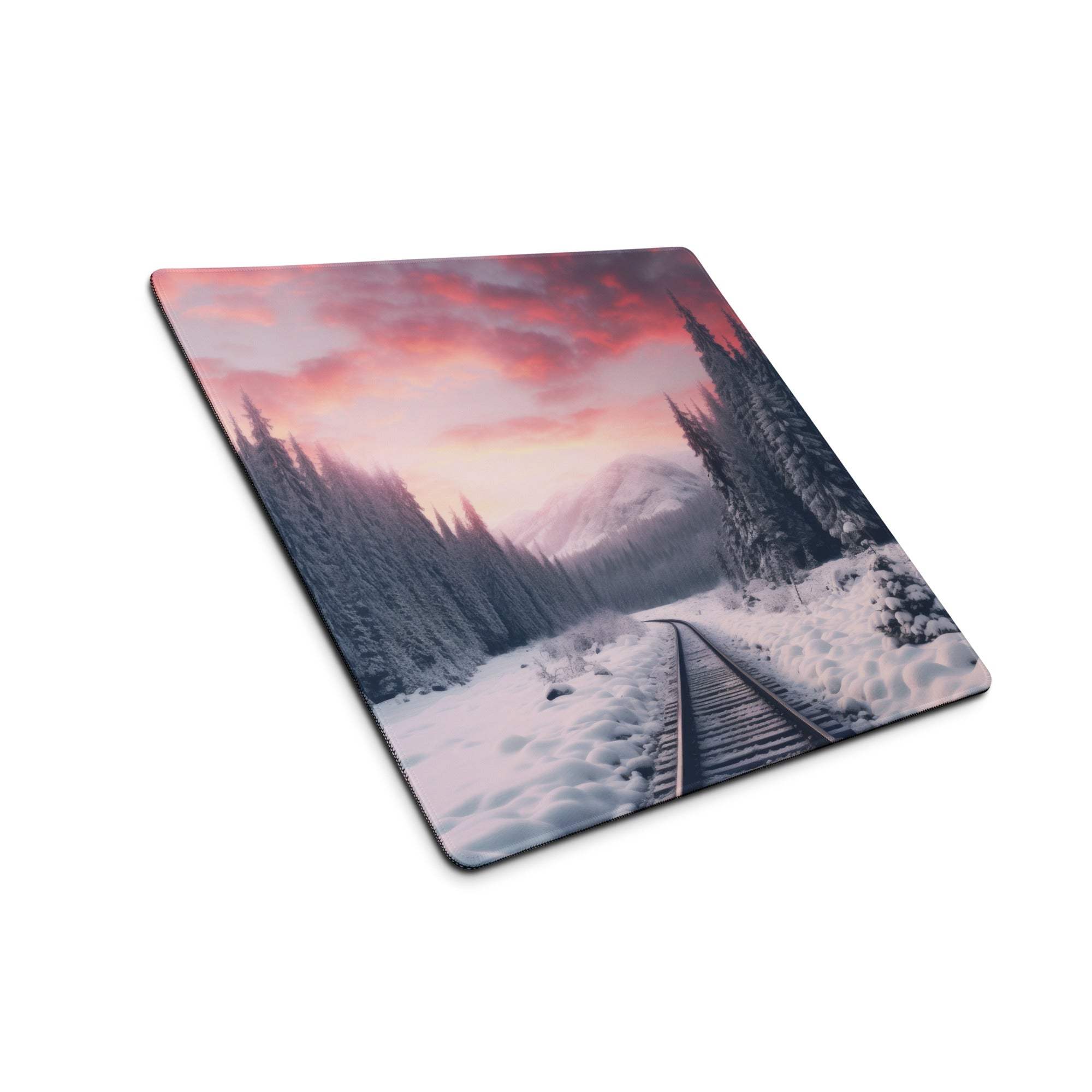 Snowy train tracks in forest on pink-orange sky gaming mouse pad