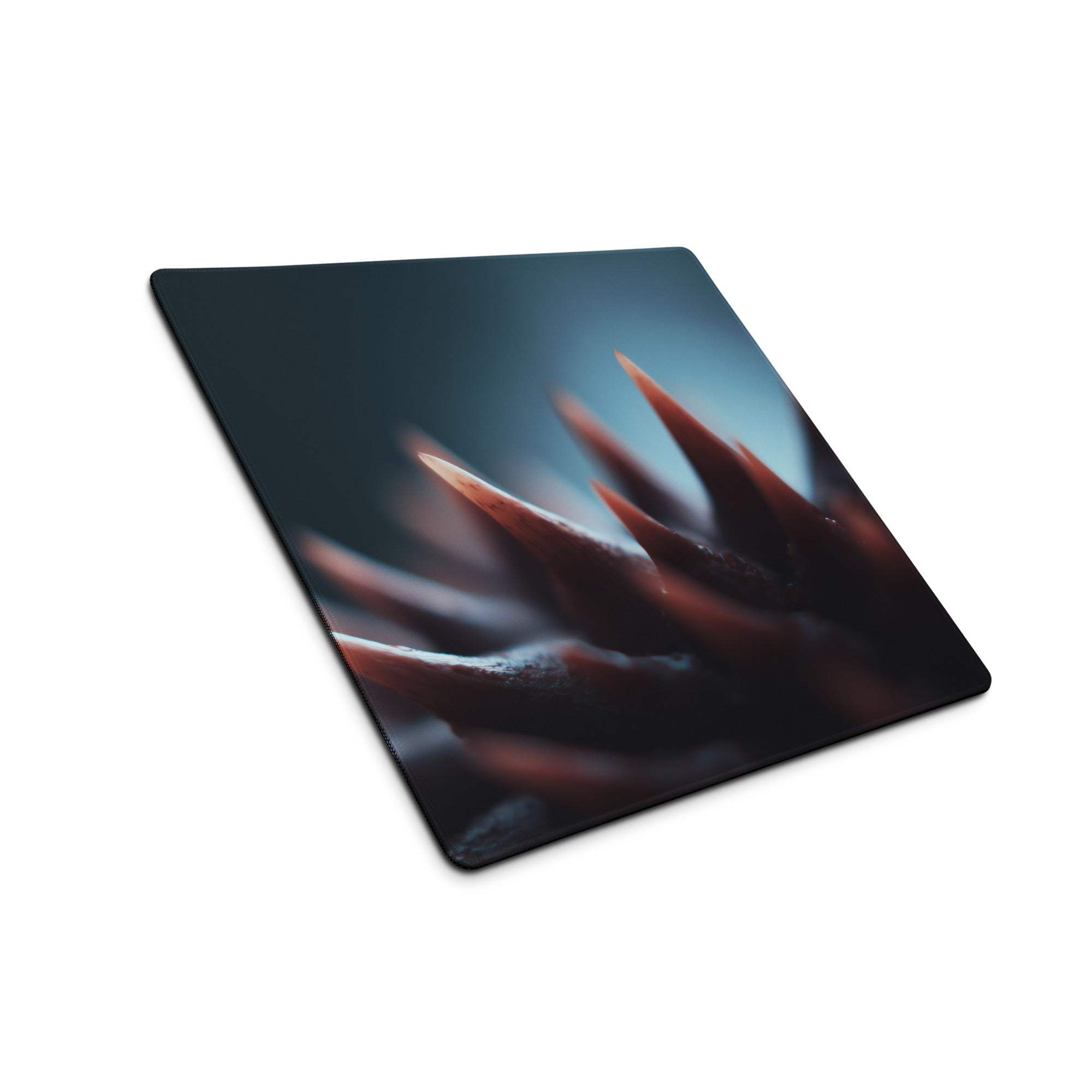 Black rectangular gaming mousepad with reddish-brown spiked motif and non-slip base