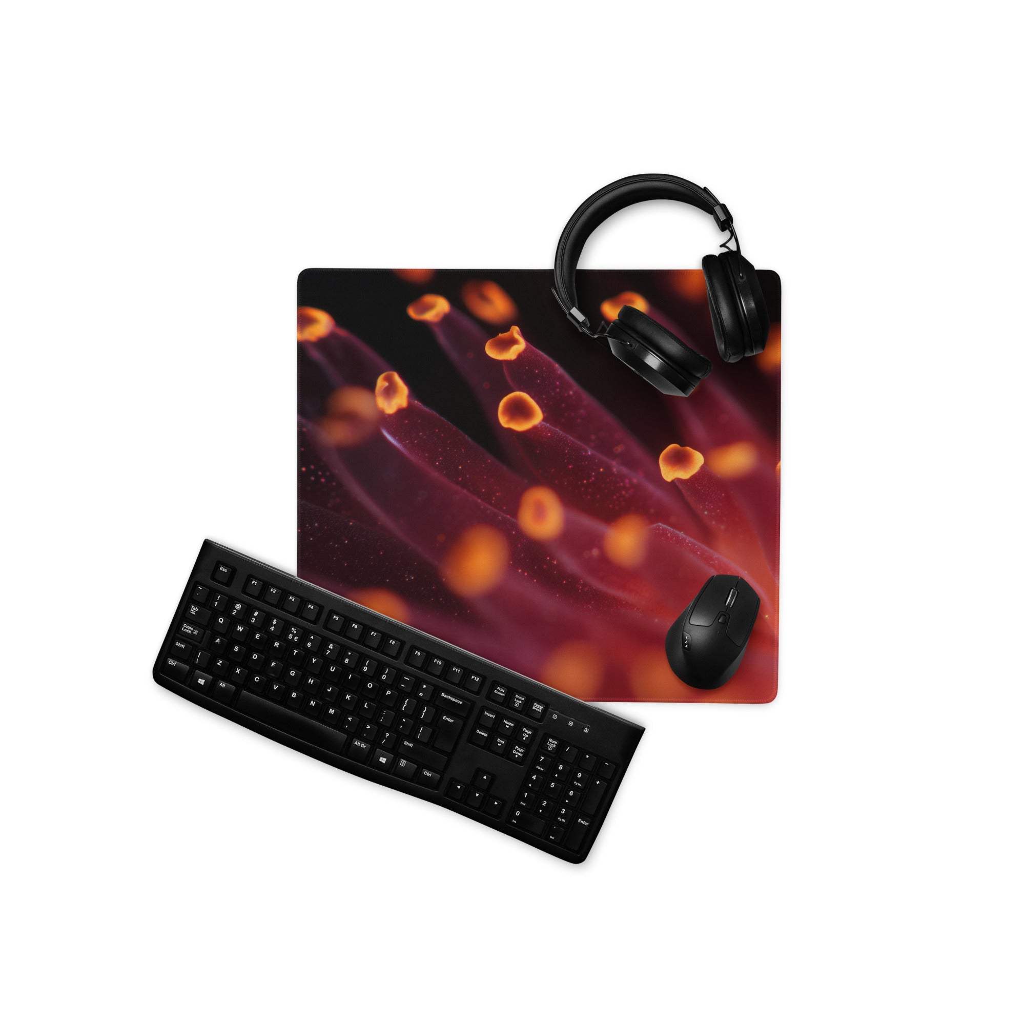 Vibrant red orange cell pattern gaming mousepad with black keyboard headphones