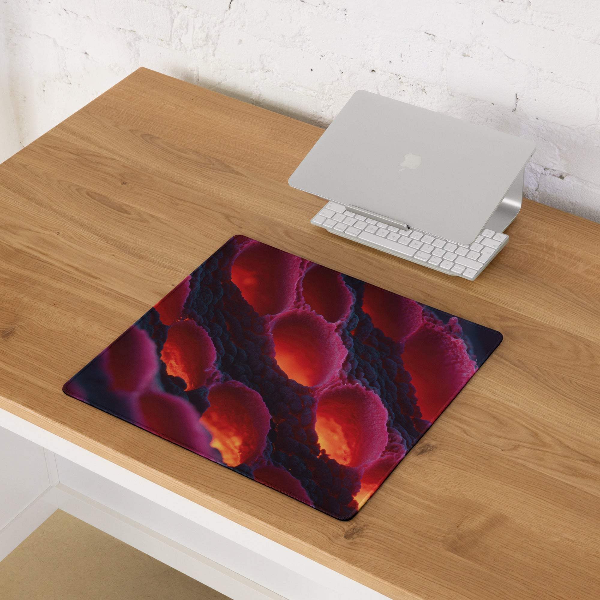 Large non-slip gaming mousepad in vibrant lava red and purple hues with edge stitching
