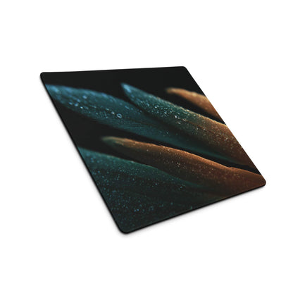Sleek teal and amber feather gaming mouse pad with water droplets