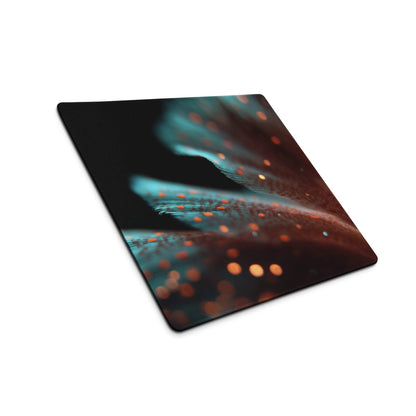 Large extended gaming mouse pad with teal orange glow feather design