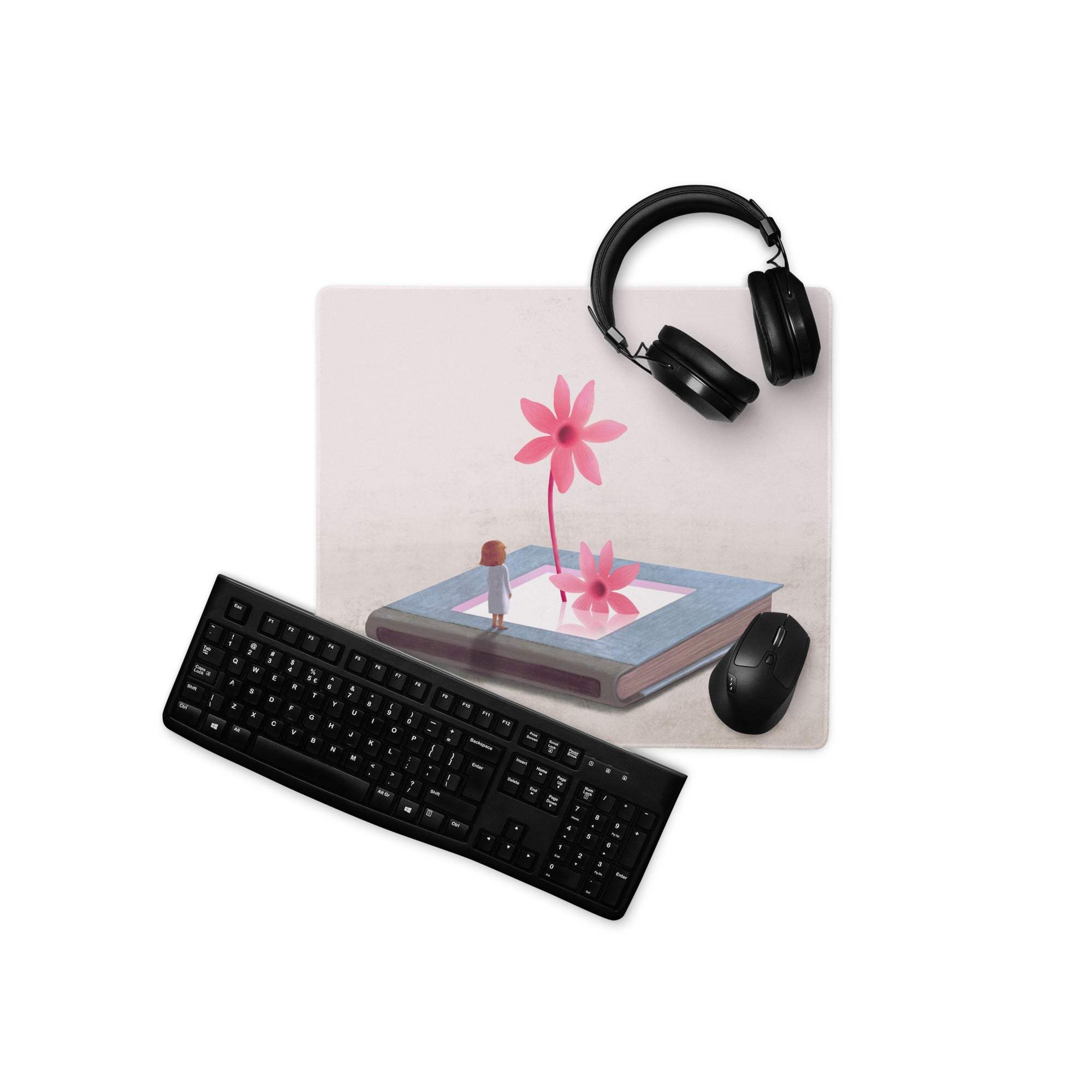 Rectangular pink floral mouse pad with pastel flower illustration and small figure on open book for office decor