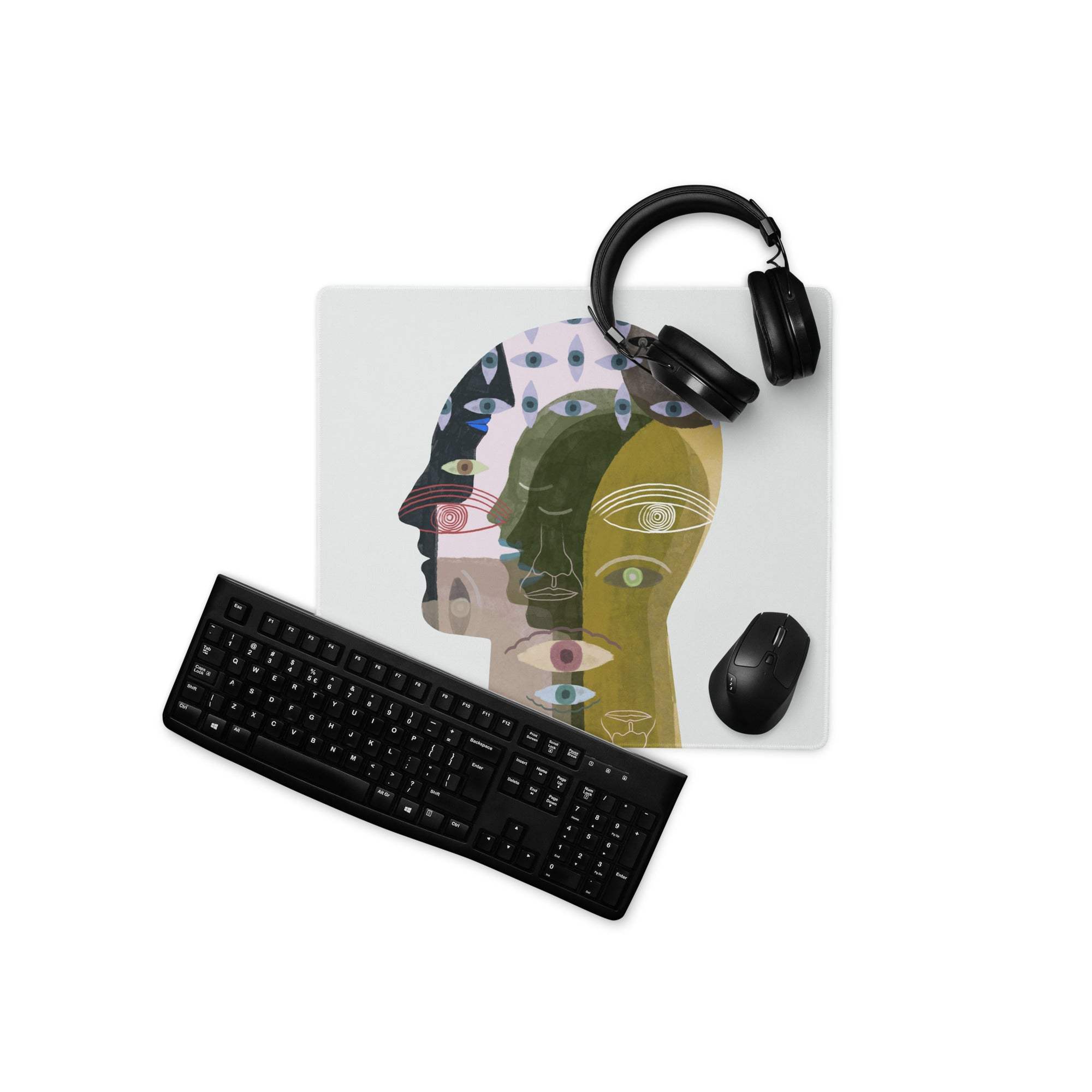 A rectangular mousepad with a colorful abstract design of overlapping human profiles in green blue and gold shades