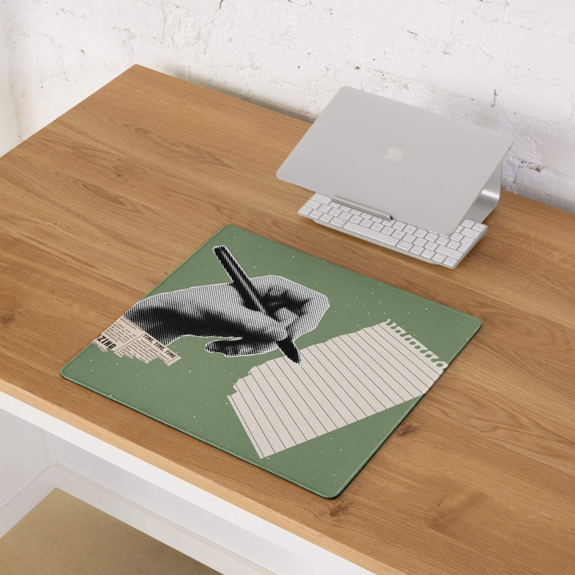 Olive green rectangular mousepad with a black and white halftone hand writing on lined paper and newspaper text accents