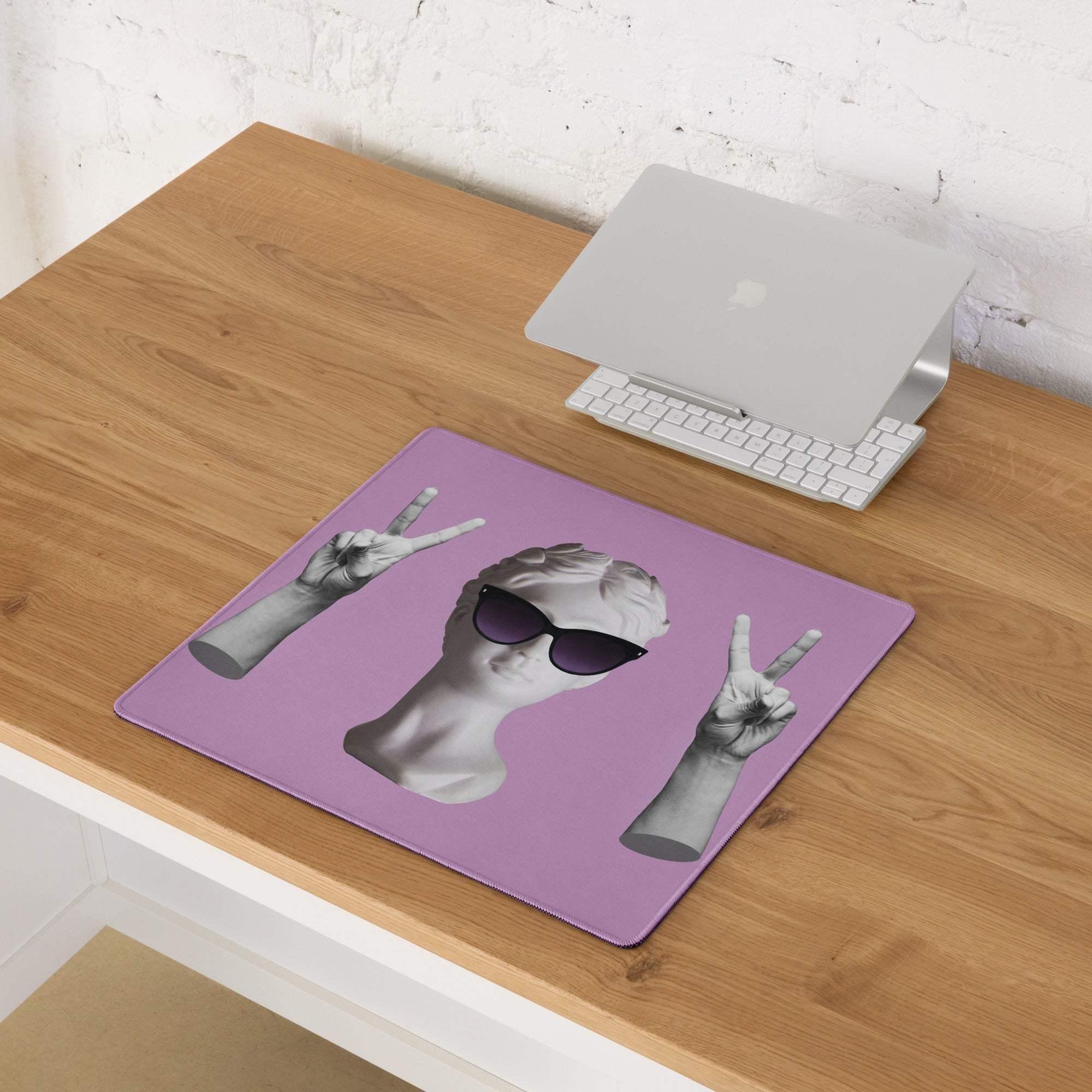 Purple rectangular mousepad with black and white classical statue head wearing sunglasses and making peace signs