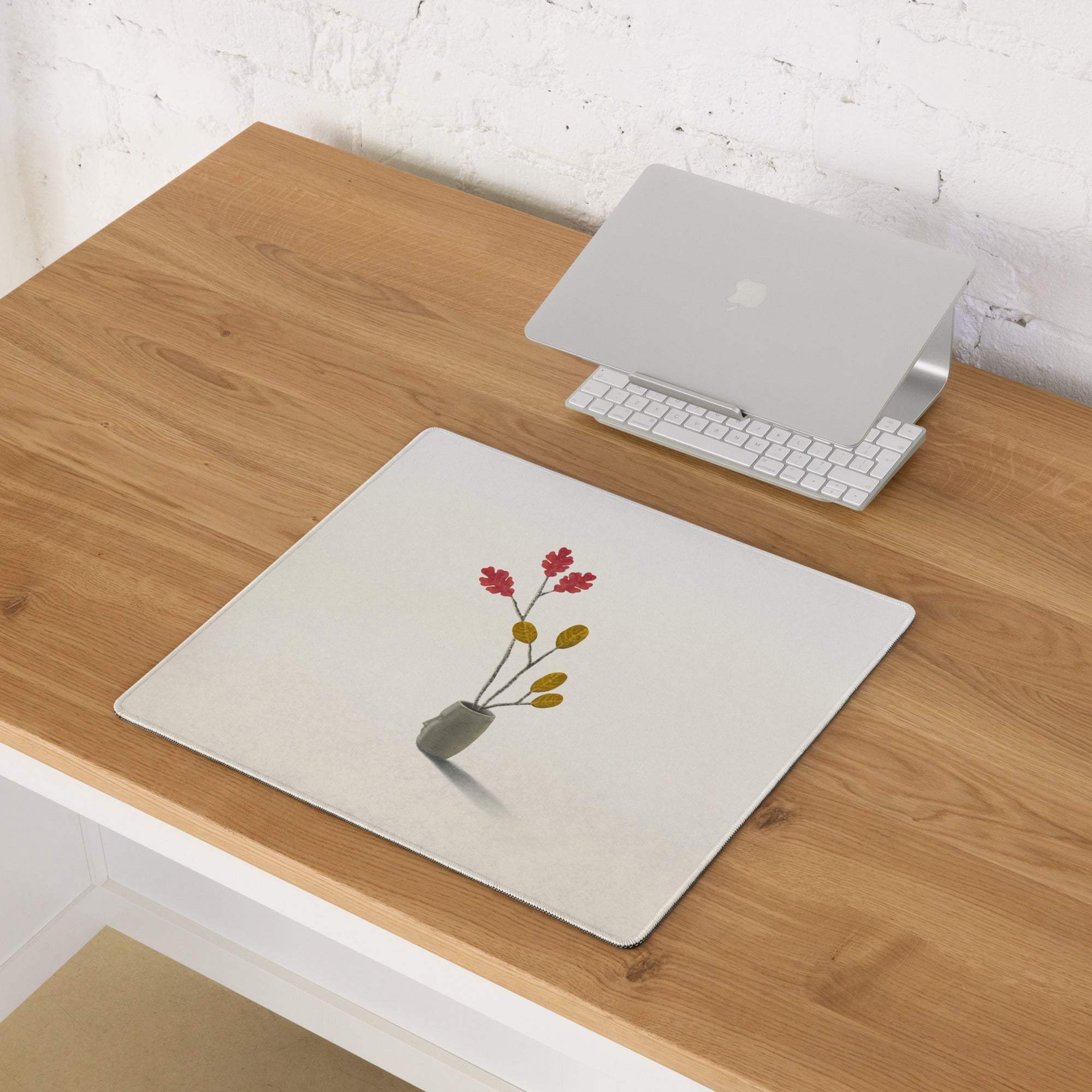 Beige botanical watercolor mouse pad with minimalist red and yellow flowers in gray vase on white rectangular surface