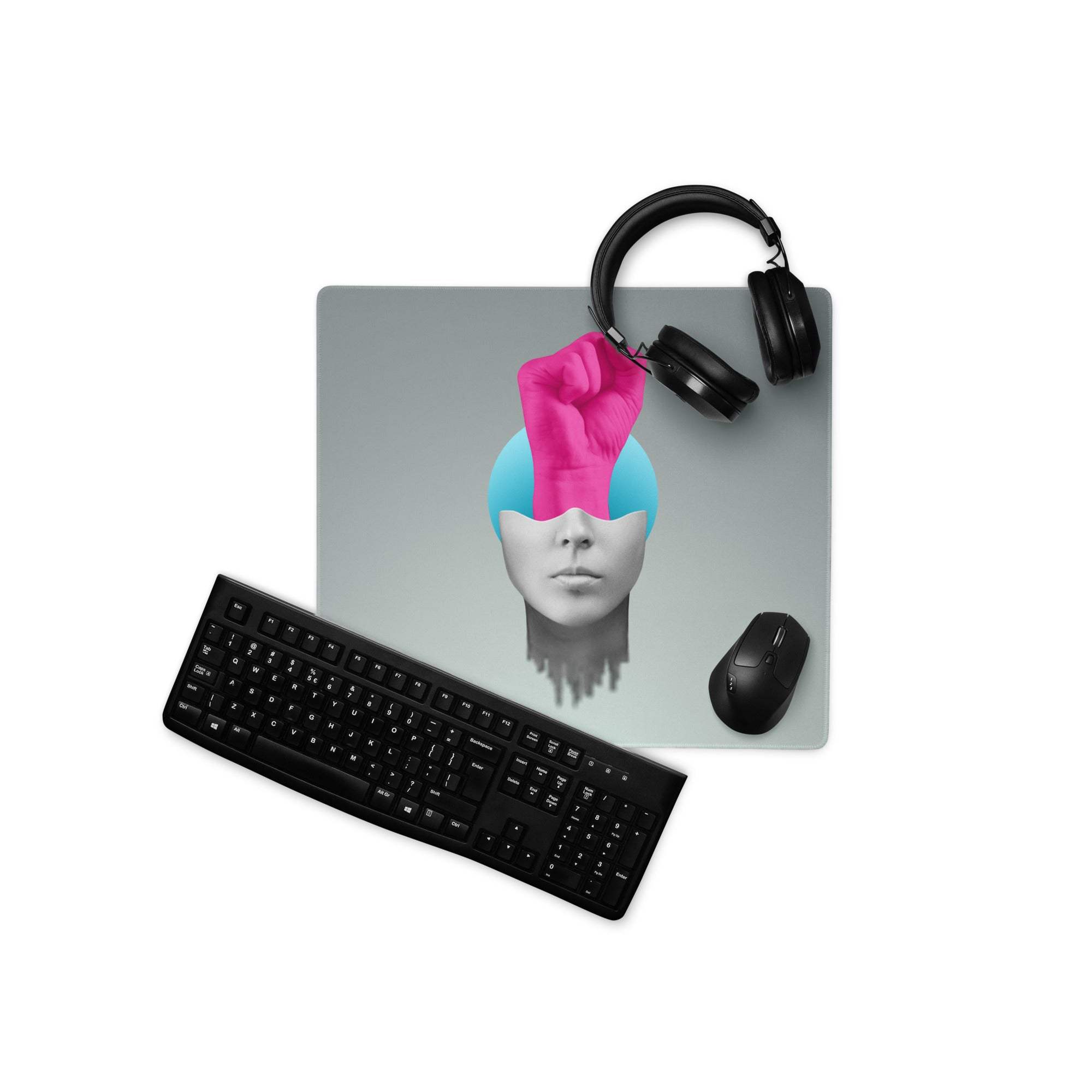 Gray mousepad desk pad featuring a pink fist head portrait with blue hair surrounded by black headphones keyboard and mouse