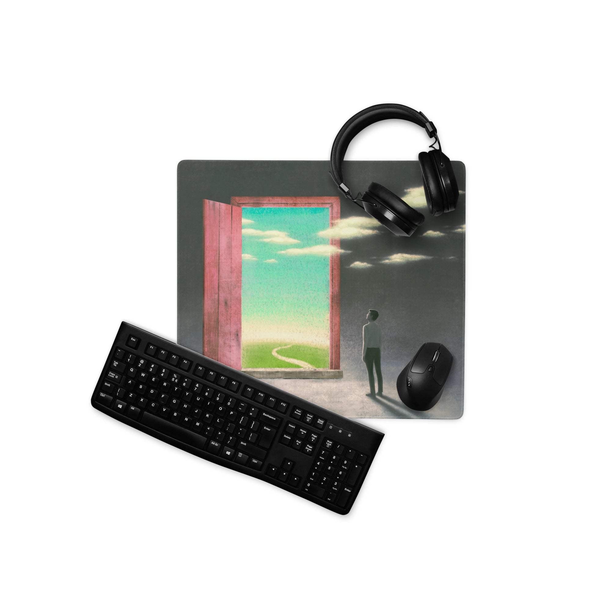 Black matte finish keyboard with standard qwerty layout on surreal pink door portal desk pad for modern office decor