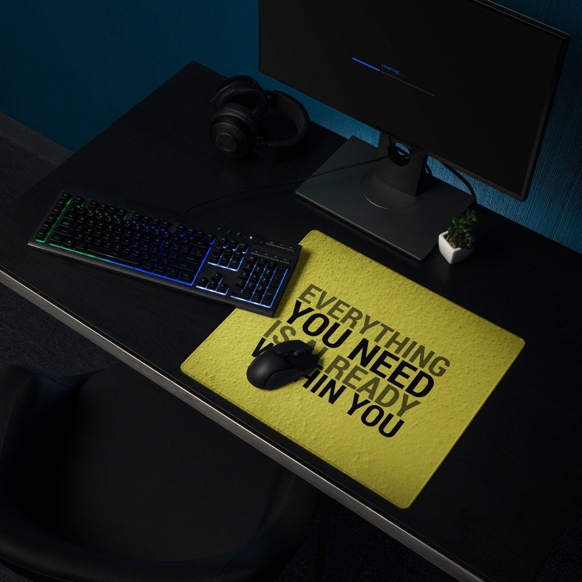 Bold yellow motivational desk pad with black textured typography on fabric reading everything you need is already in you