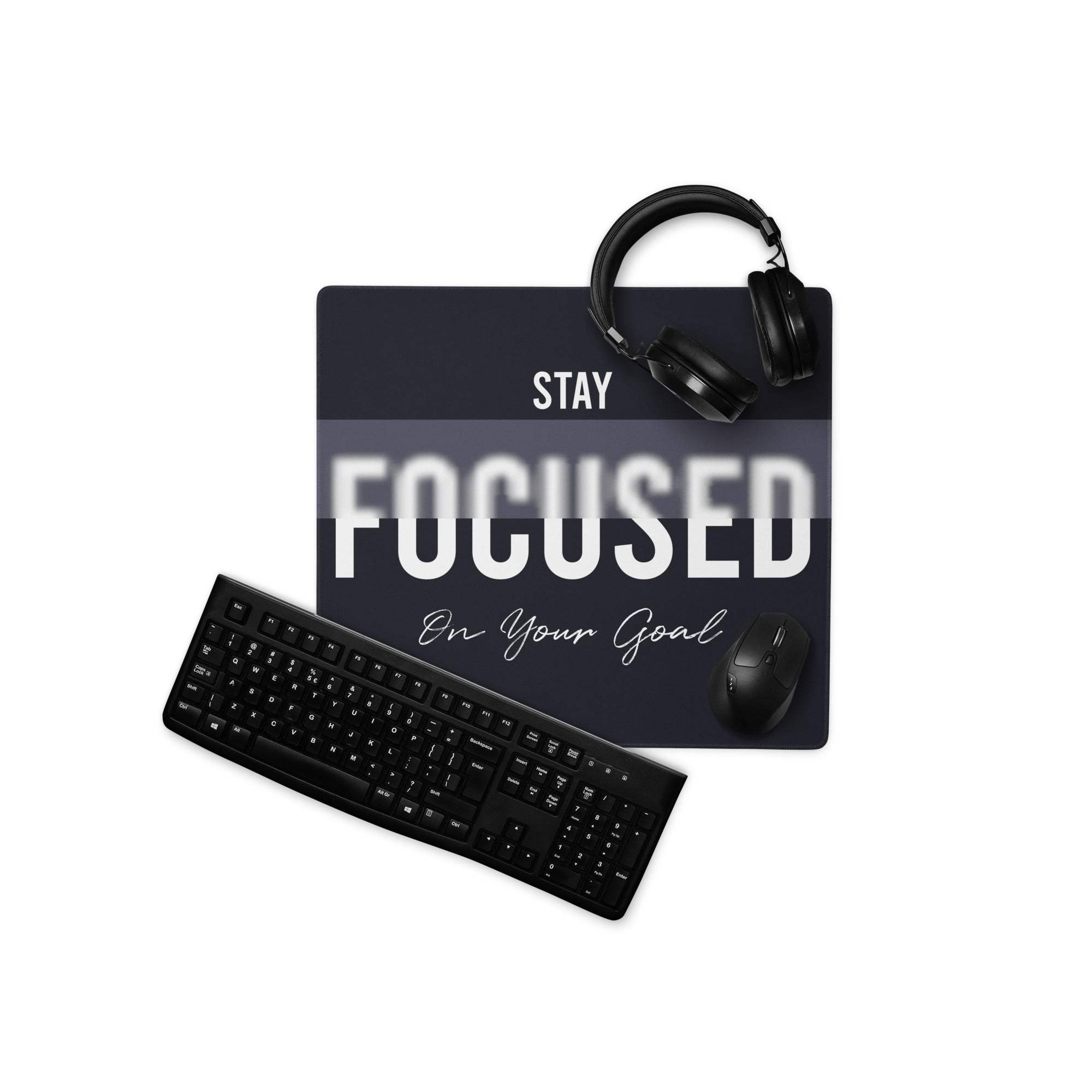 Black mousepad with stay focused on your goal text and gray gradient featuring black headphones for a minimalist workspace