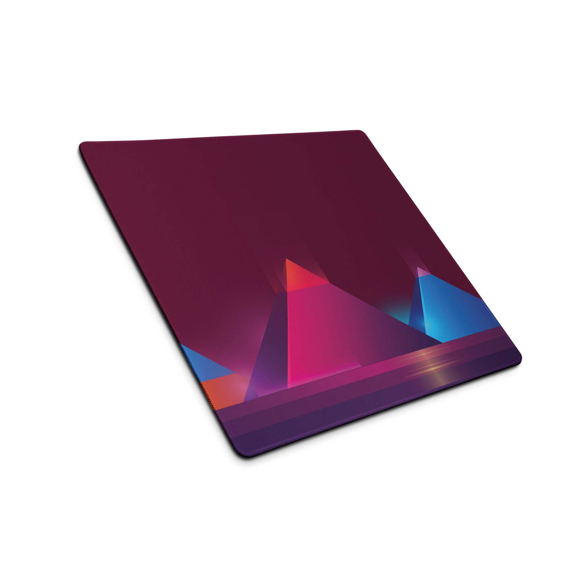 A square-shaped vibrant geometric gaming mouse pad with magenta and blue pyramids on a deep maroon background