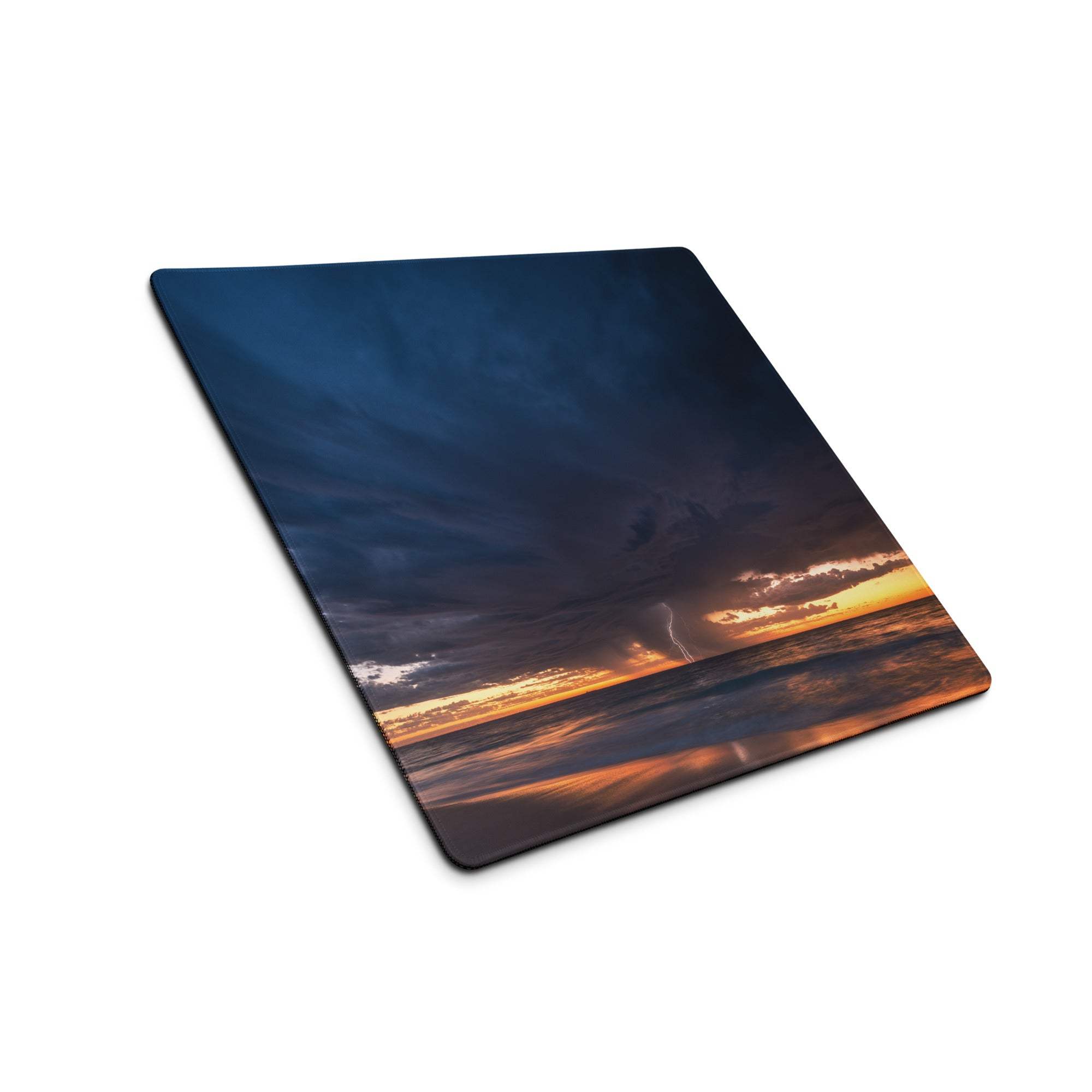 Stormy sky desk pad with dark blue and orange ocean sunset colors and a printed lightning bolt design for gaming setup