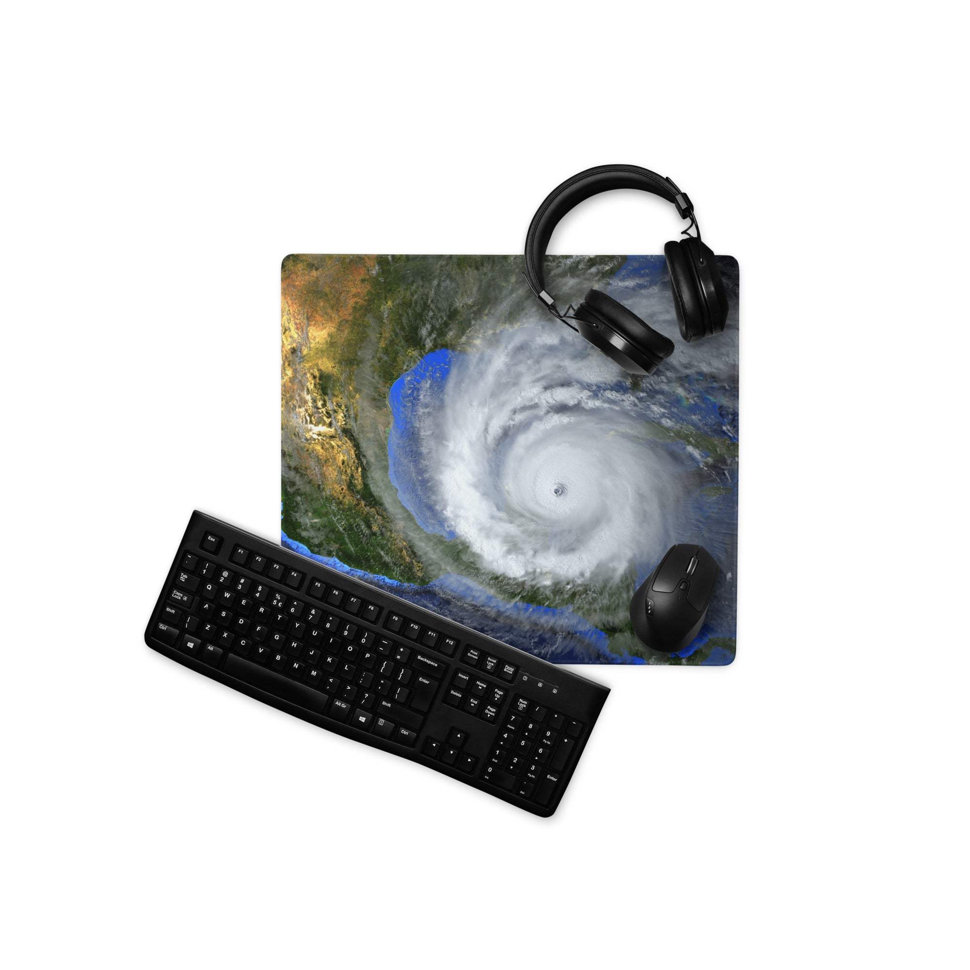 Black keyboard and mouse on storm eye satellite desktop pad featuring vivid hurricane earth blue orange gray art