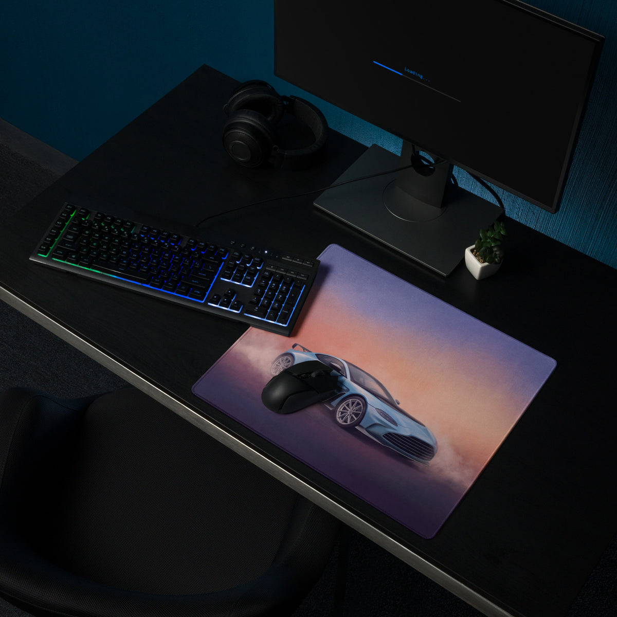 A rectangular non-slip pc mousepad featuring a light blue aston martin vantage gt3 against a sunset sky gradient